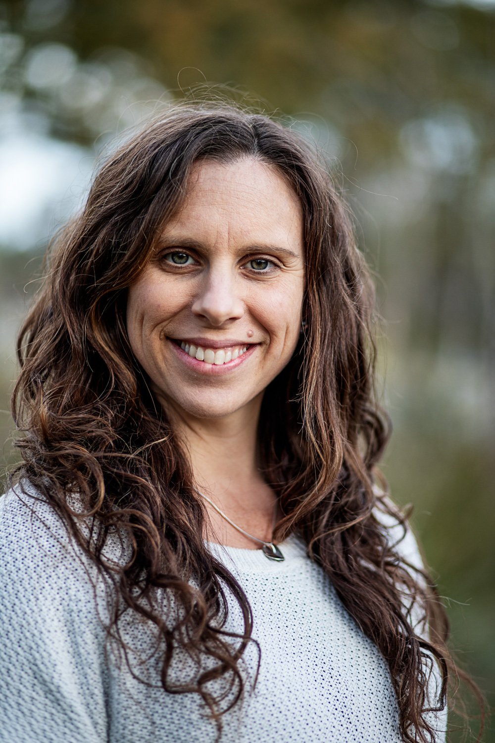 Claire Holloway, Matrescence Coach and Bowen Therapist, facilitating a community healing circle.