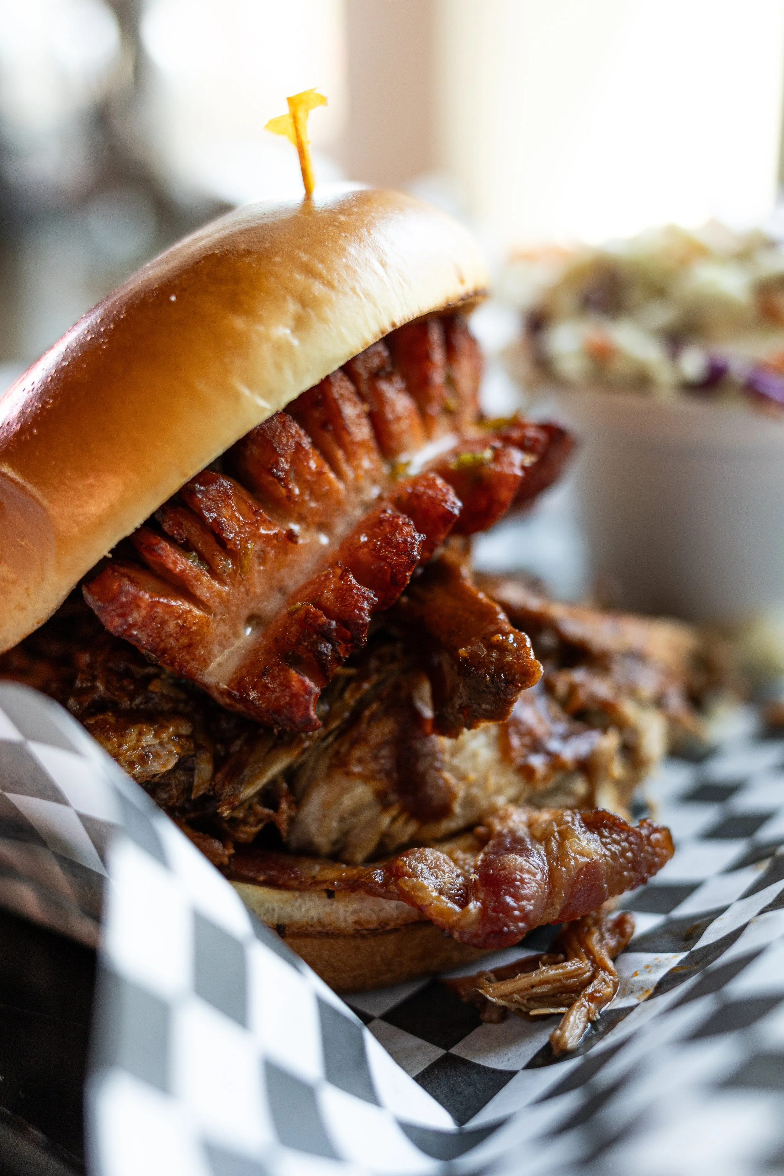 bun with sausage, bacon and pulled pork