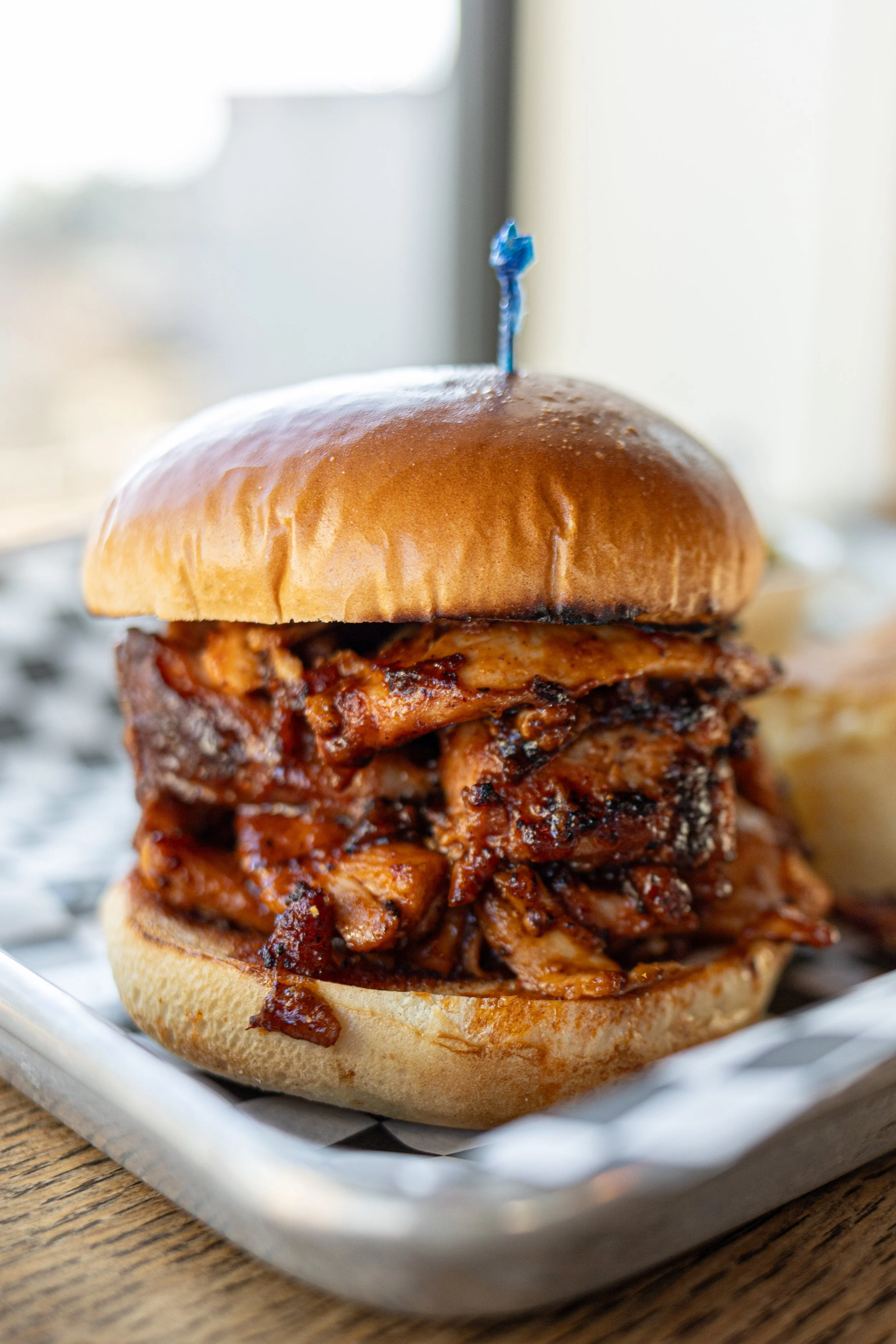 toasted bun with large amount of pulled chicken