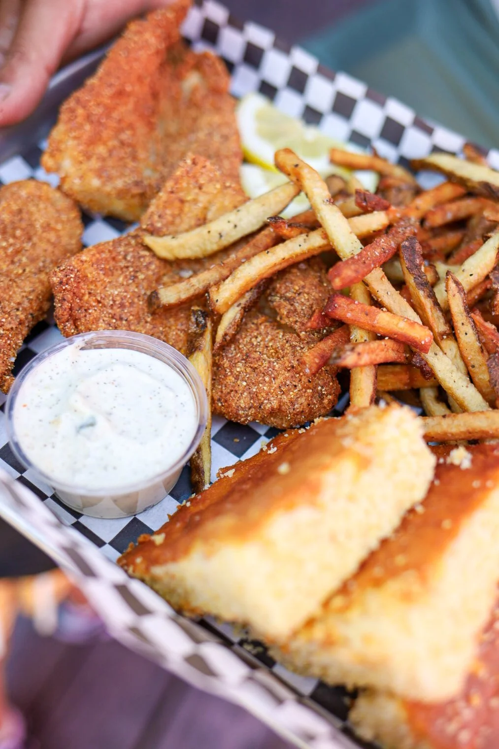 platter with catfish, fries and cornbread with sauce
