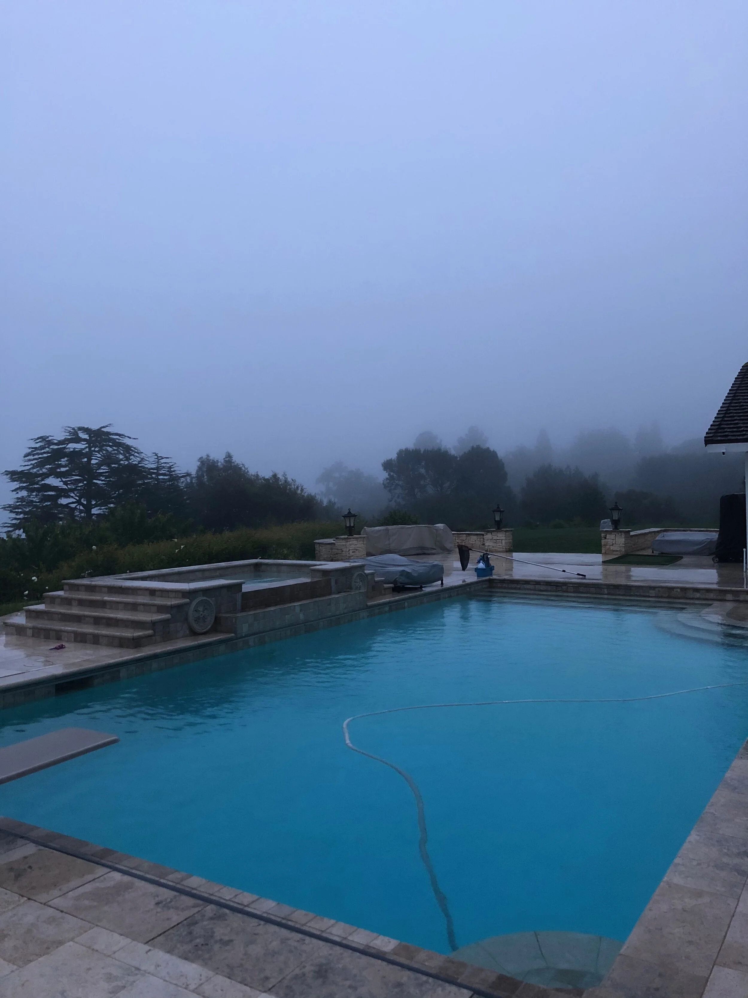 Salt water pool and spa combo with cleaner and equipment below level