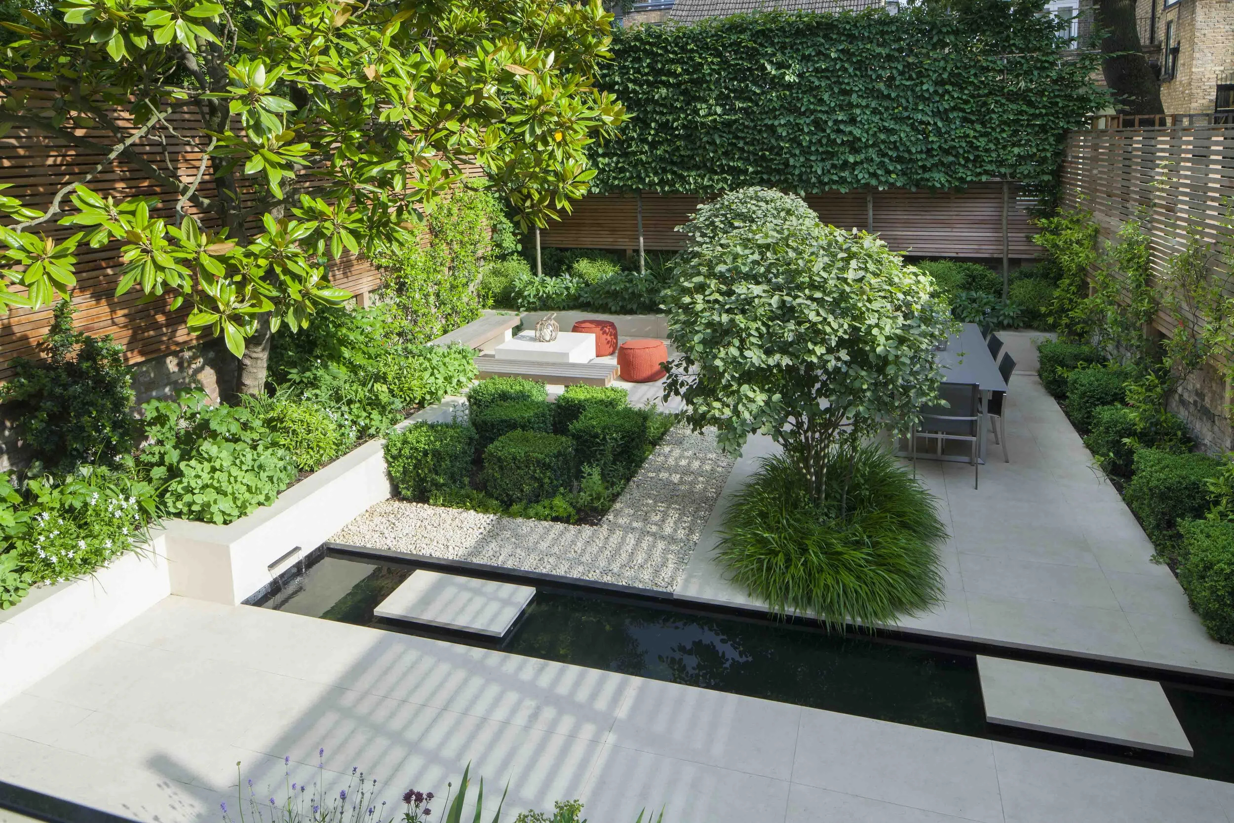 Town garden London water rill feature terrace seating climbers cream limestone pleached trees gravel Charlotte Rowe Marianne Majerus