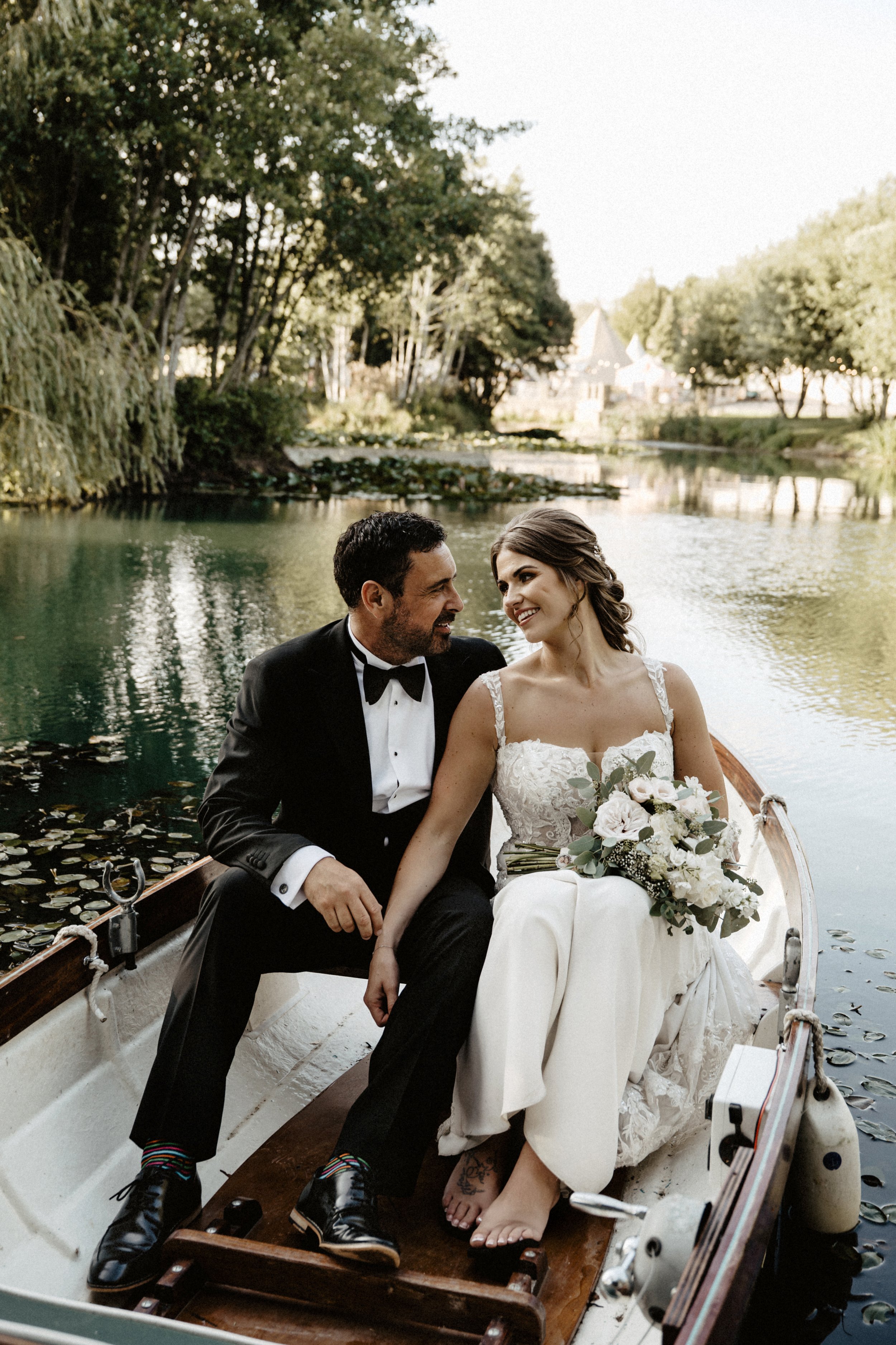 bride and groom in boat at lake henry