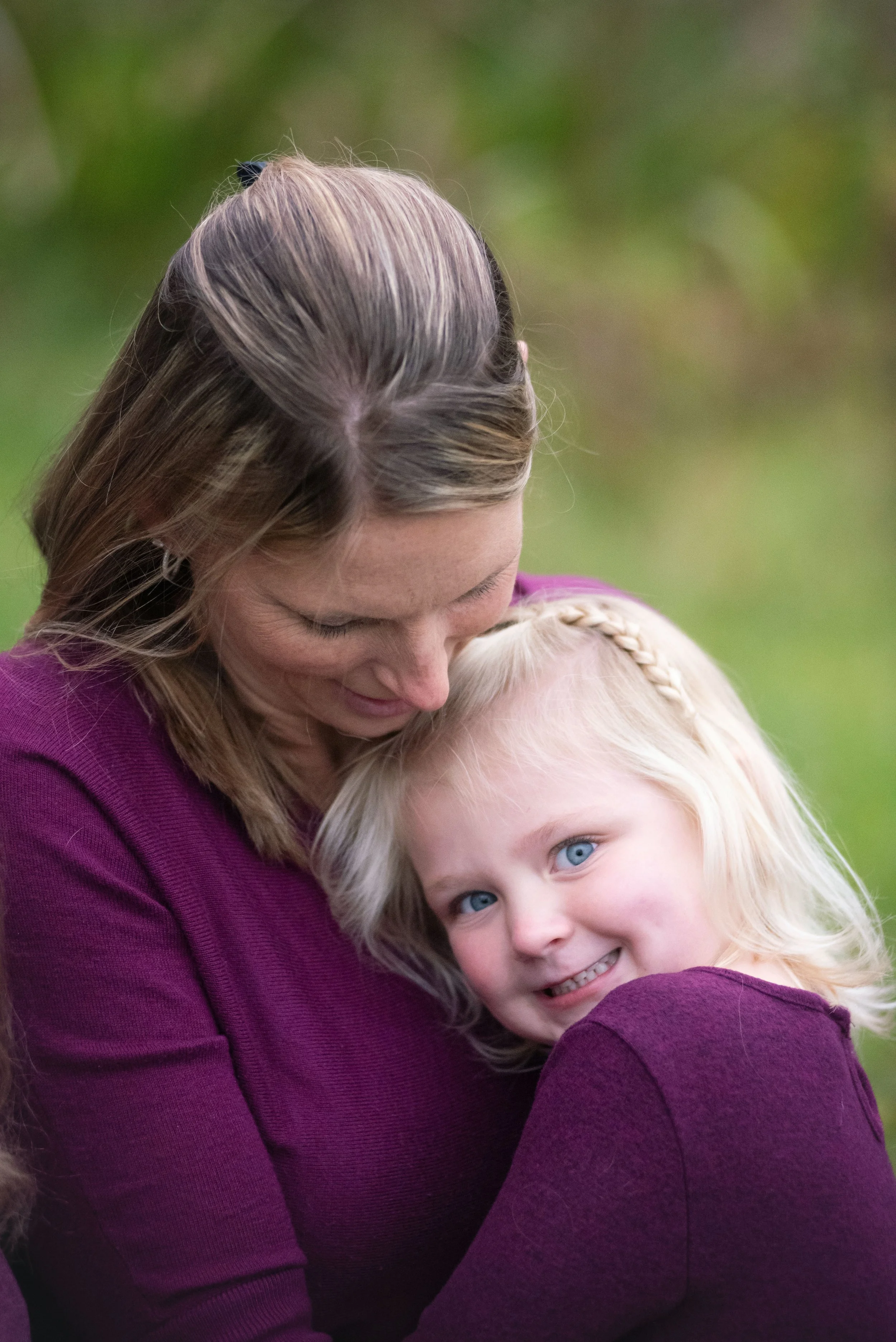 mom and daughter cuddling in a sweet moment together at a family photo session in Charlotte, NC