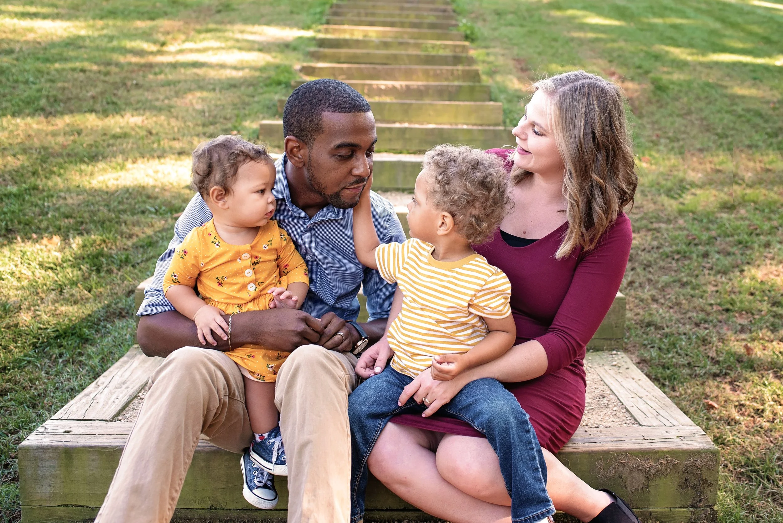 family sharing a sweet moment together, shot at Dogwood Park, Wesley Chapel, NC
