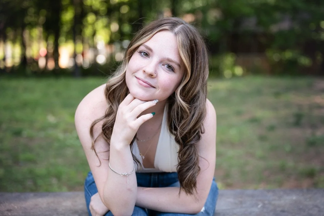 Relaxed photo of high school senior with soft smile at Marvin Efird Park, Marvin, NC