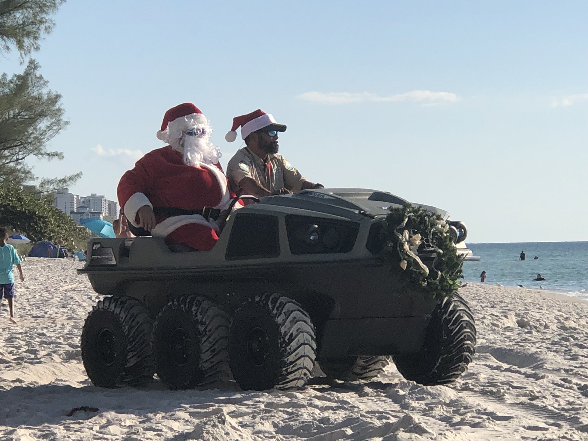 Santa rolls on a beach ATV down here!