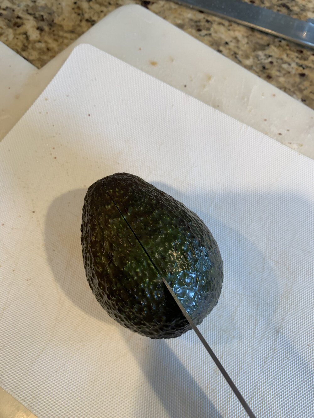 Step 2: Cut the avocado in half