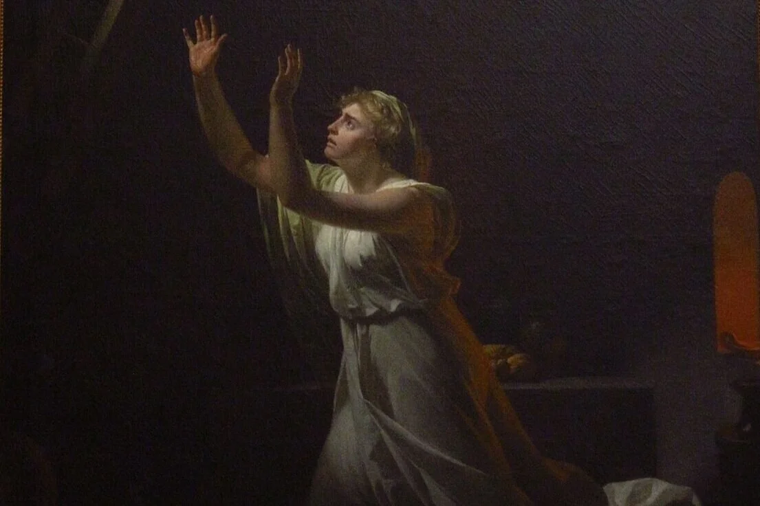 a woman in a white dress is surrounded by darkness. she reaches for a ladder as a hand reaches down to withdraw it from above