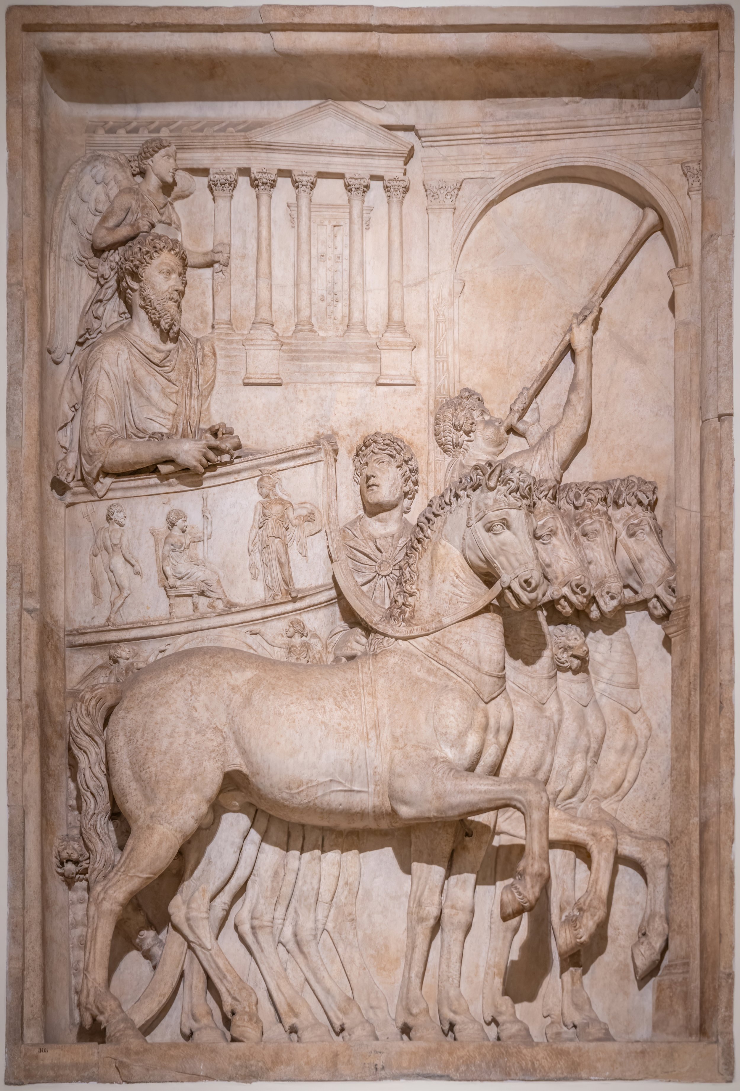 marble relief sculpture showing classical Roman theme, with men and a horse-drawn chariot