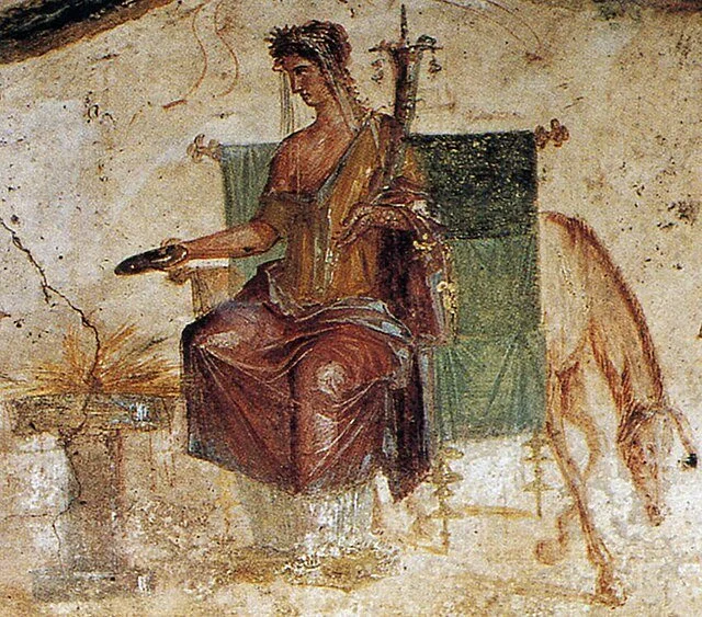 ancient fresco of a seated goddess holding an offering plate over a fire