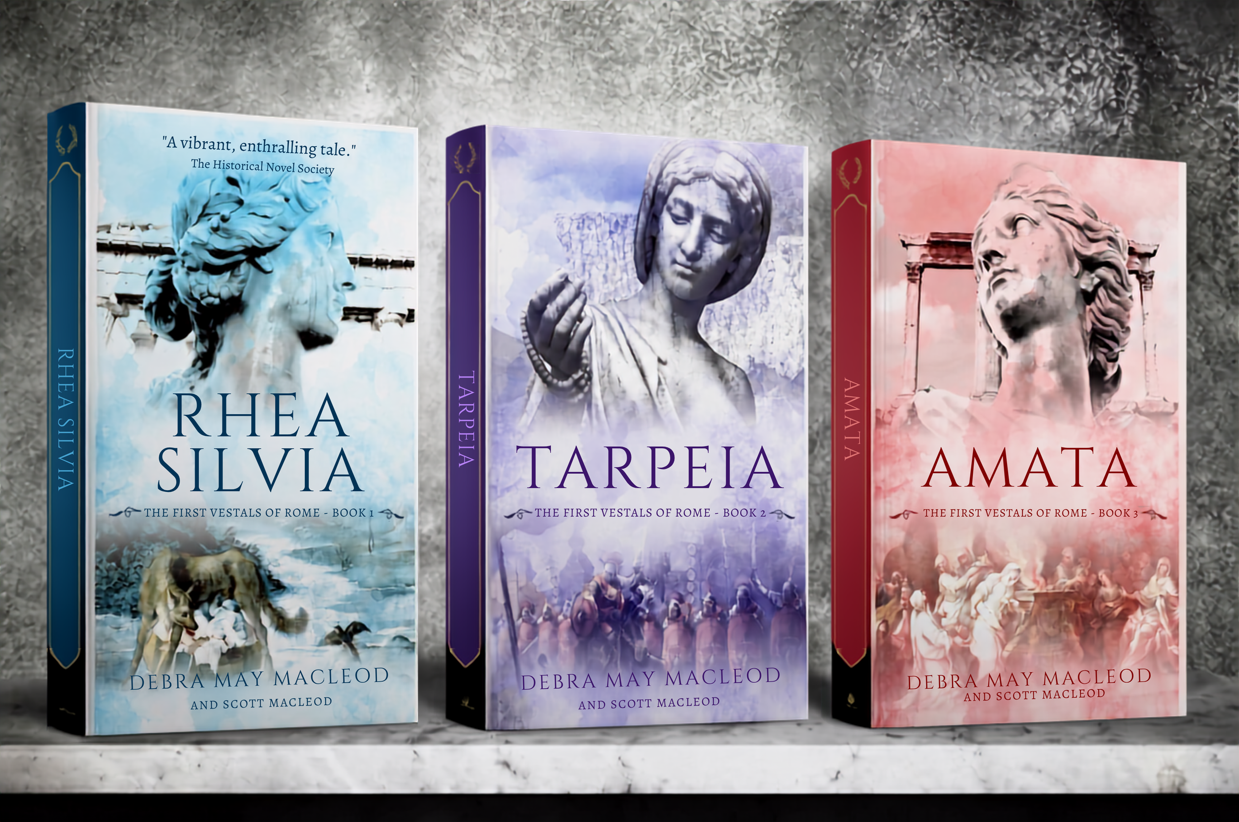 image of three books on a gray marble shelf, Rhea Silvia, Tarpeia and Amata, all by Debra May Macleod