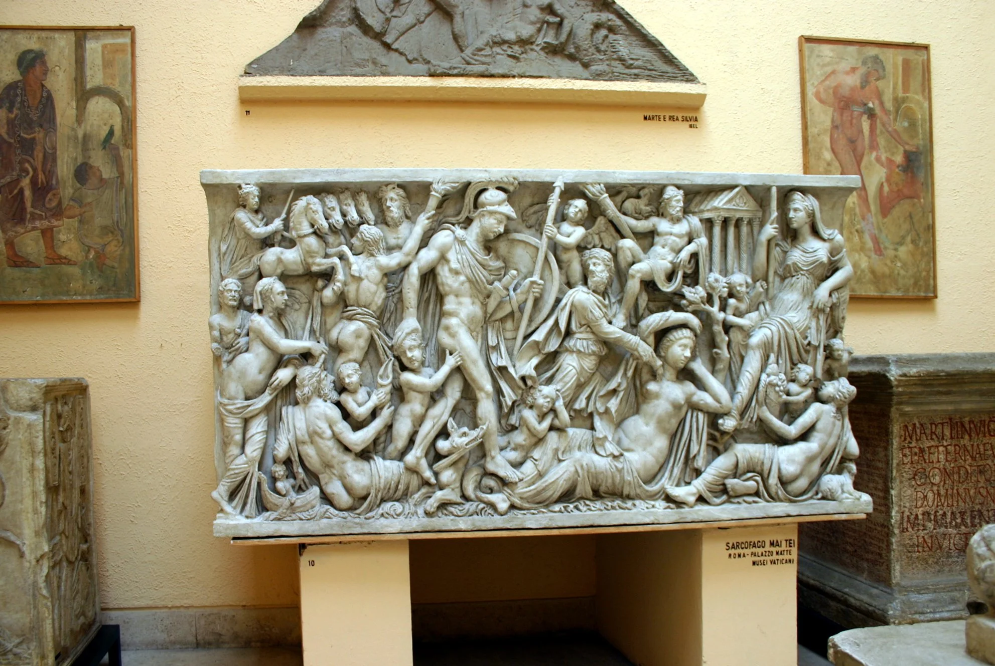 an image, in sculpture, of a reclining woman being approached by a man in Roman military attire