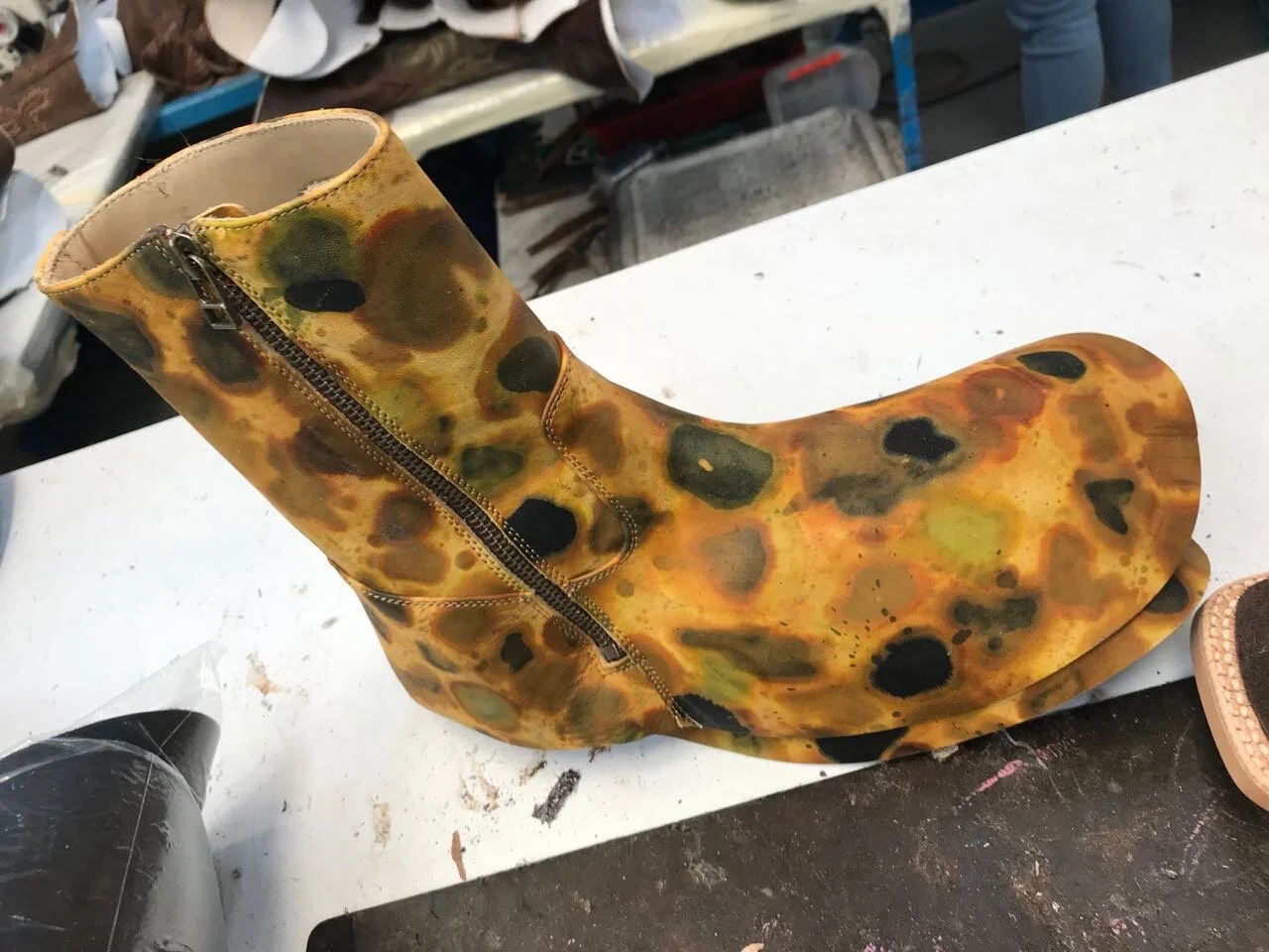 Italian Calf.  Dye is dripped by syringe onto rocks. Process picture of the boot shown pre-lasting & finishing. . 