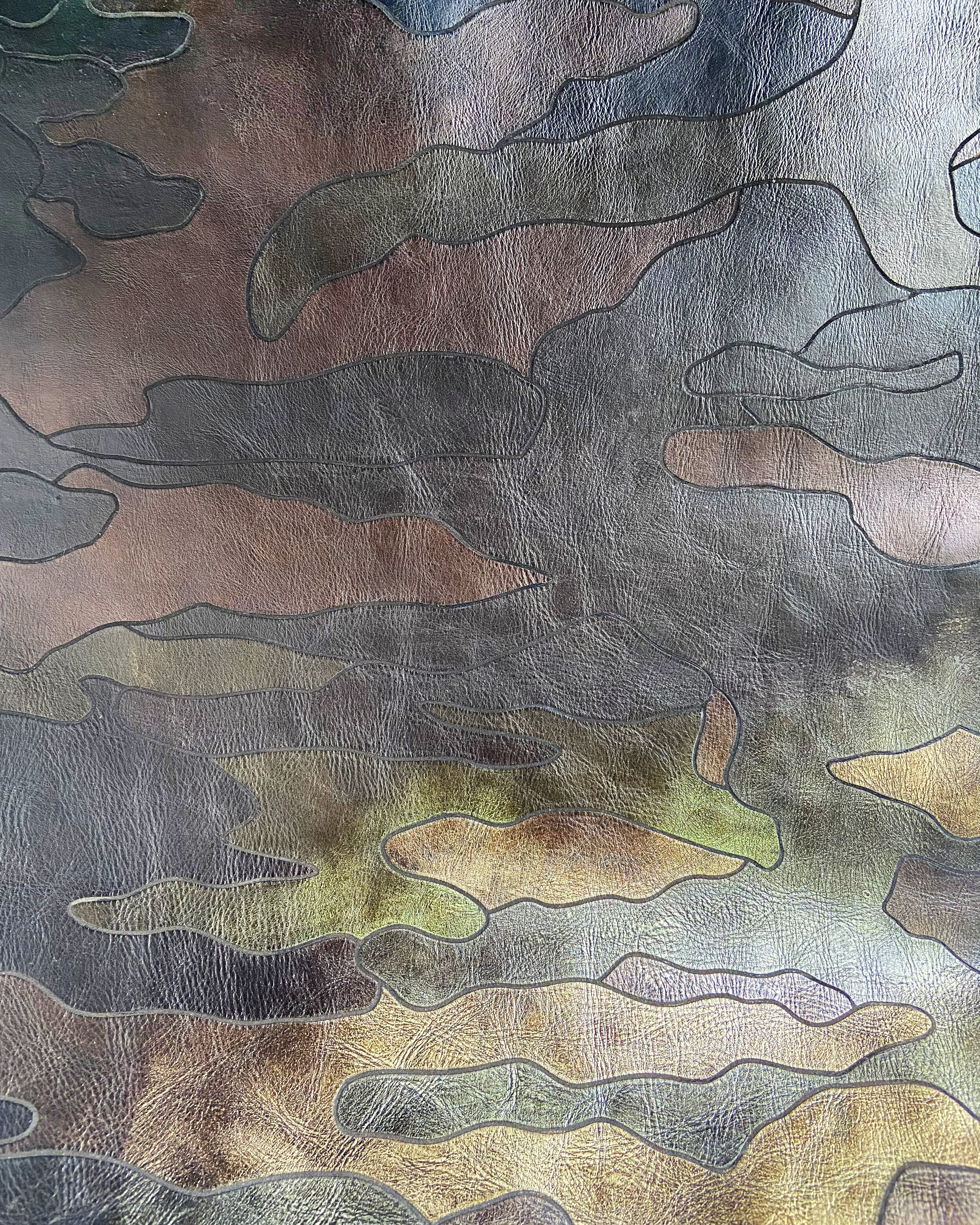 laser engraved camo pattern inspired by the traditional Woodland pattern from the US army, metallic foils applied by hand, with further finishing