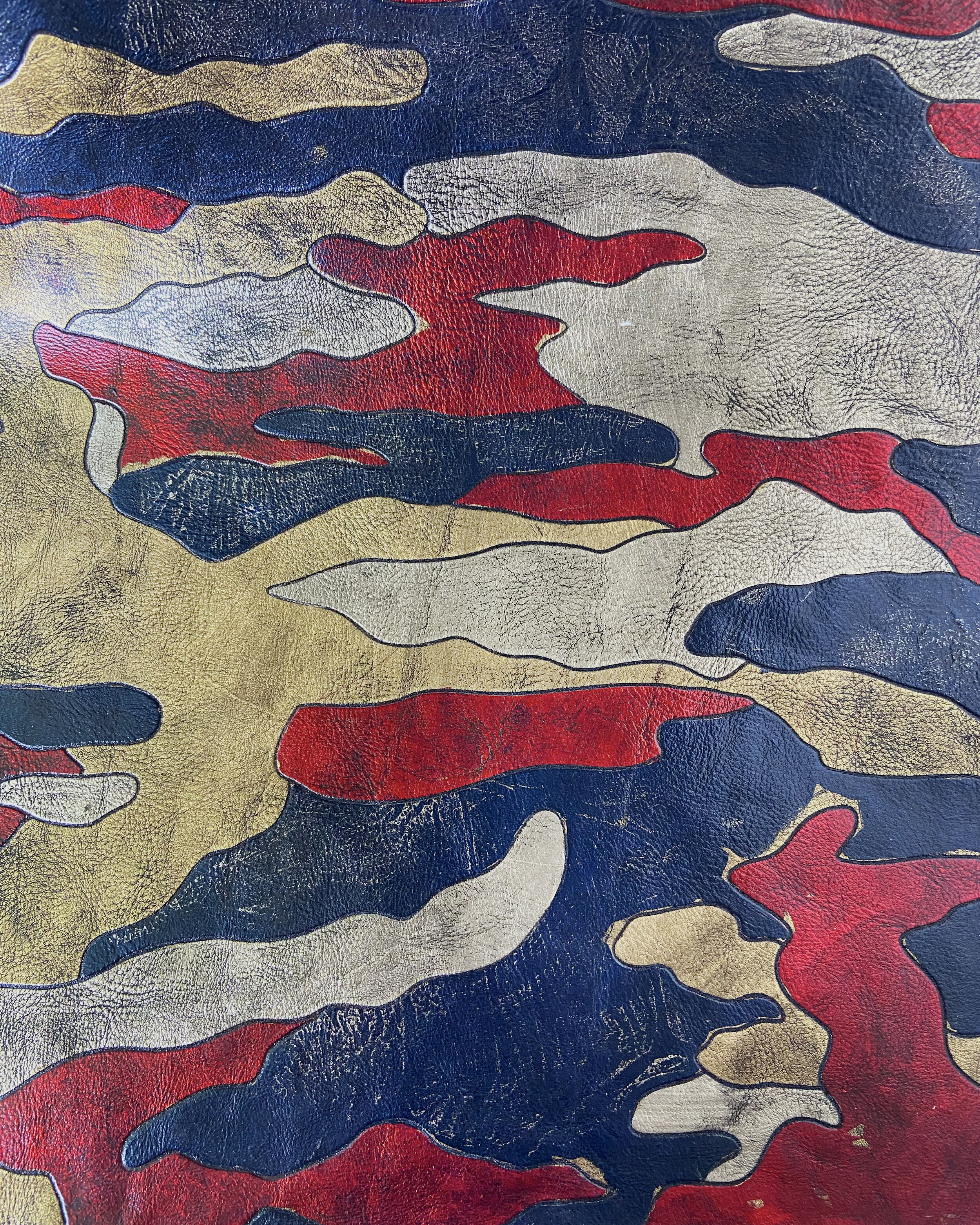 laser engraved camo pattern inspired by the traditional Woodland pattern from the US army, metallic foils applied by hand, with further finishing
