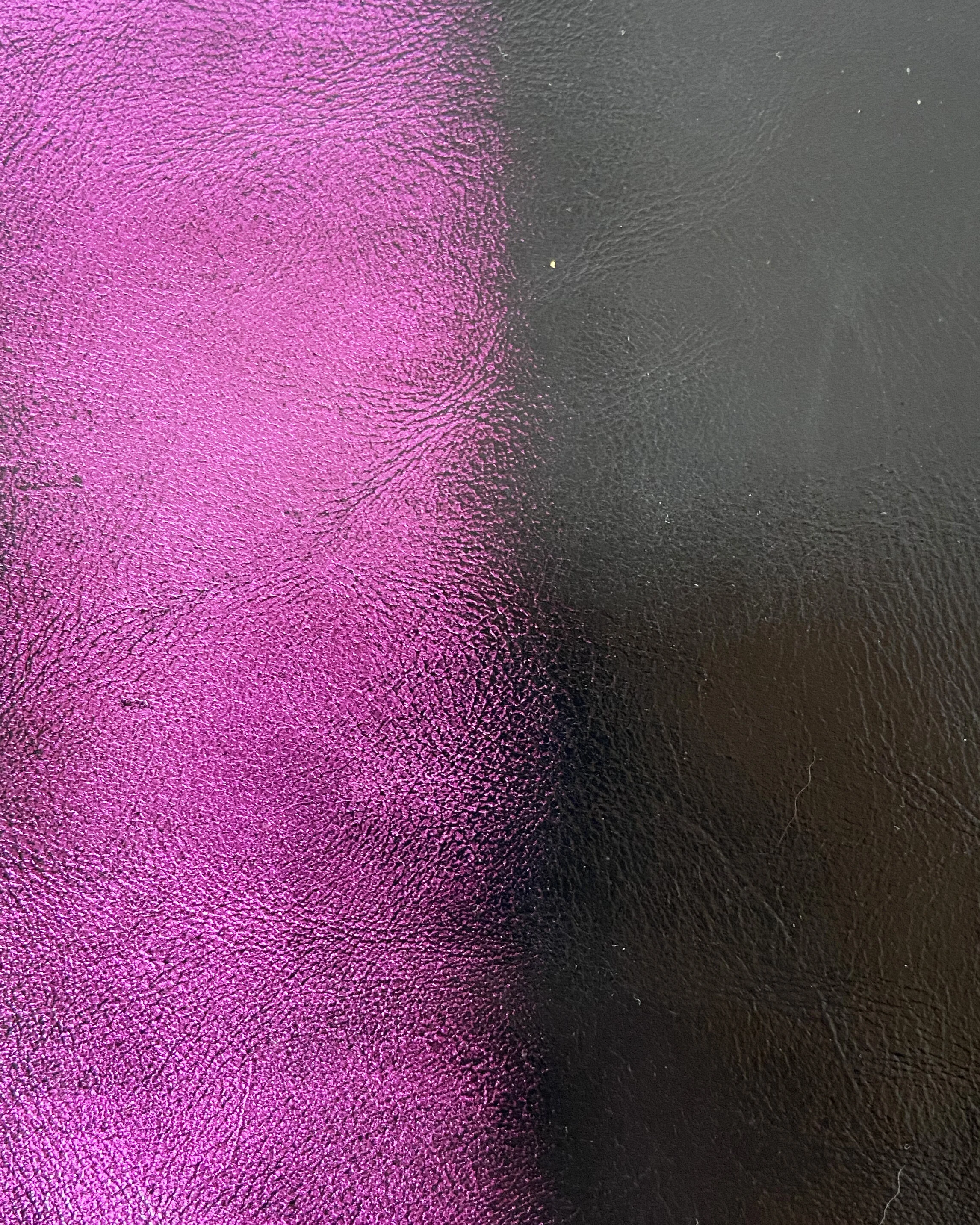 Metallic with a black brushoff shadow. This leather is designed on a black base crust to be laser engraved.