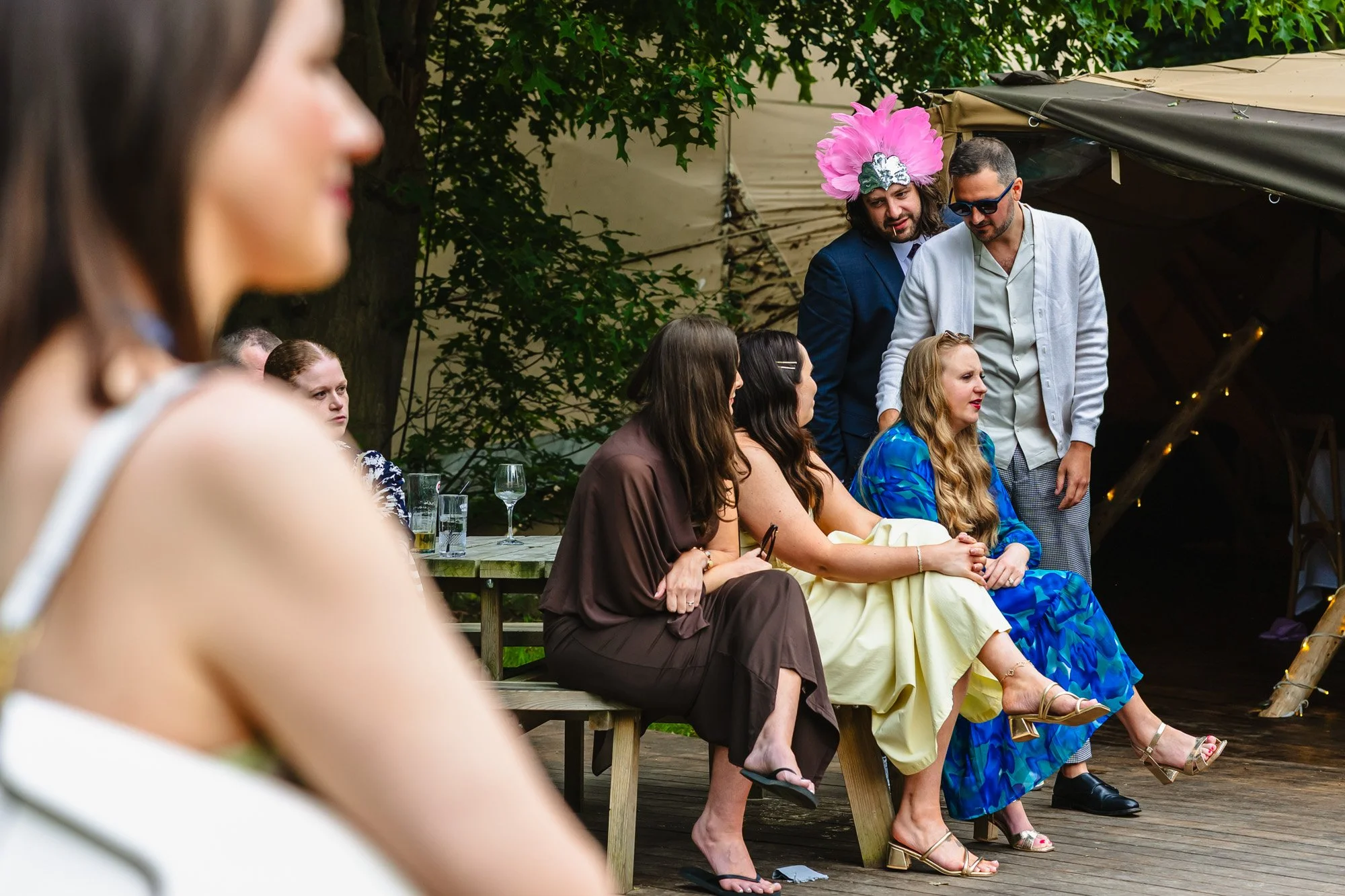 photograph of a group of wedding guests at Whatton House tipis during speeches taken by documentary wedding photographer Caroline Goosey