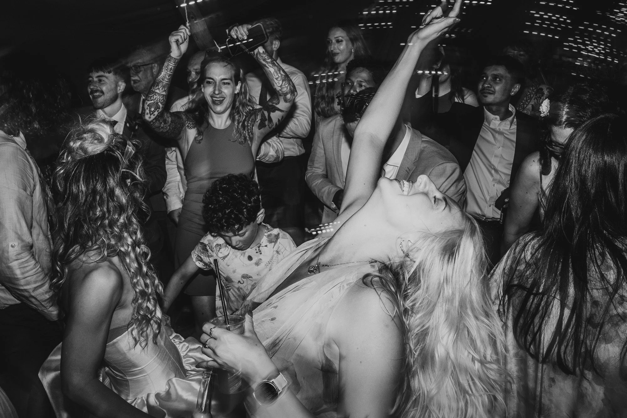 photograph of a busy wedding dancefloor in the tipi at Duddon Mill Farm in Cheshire by Cheshire wedding photographer Caroline Goosey