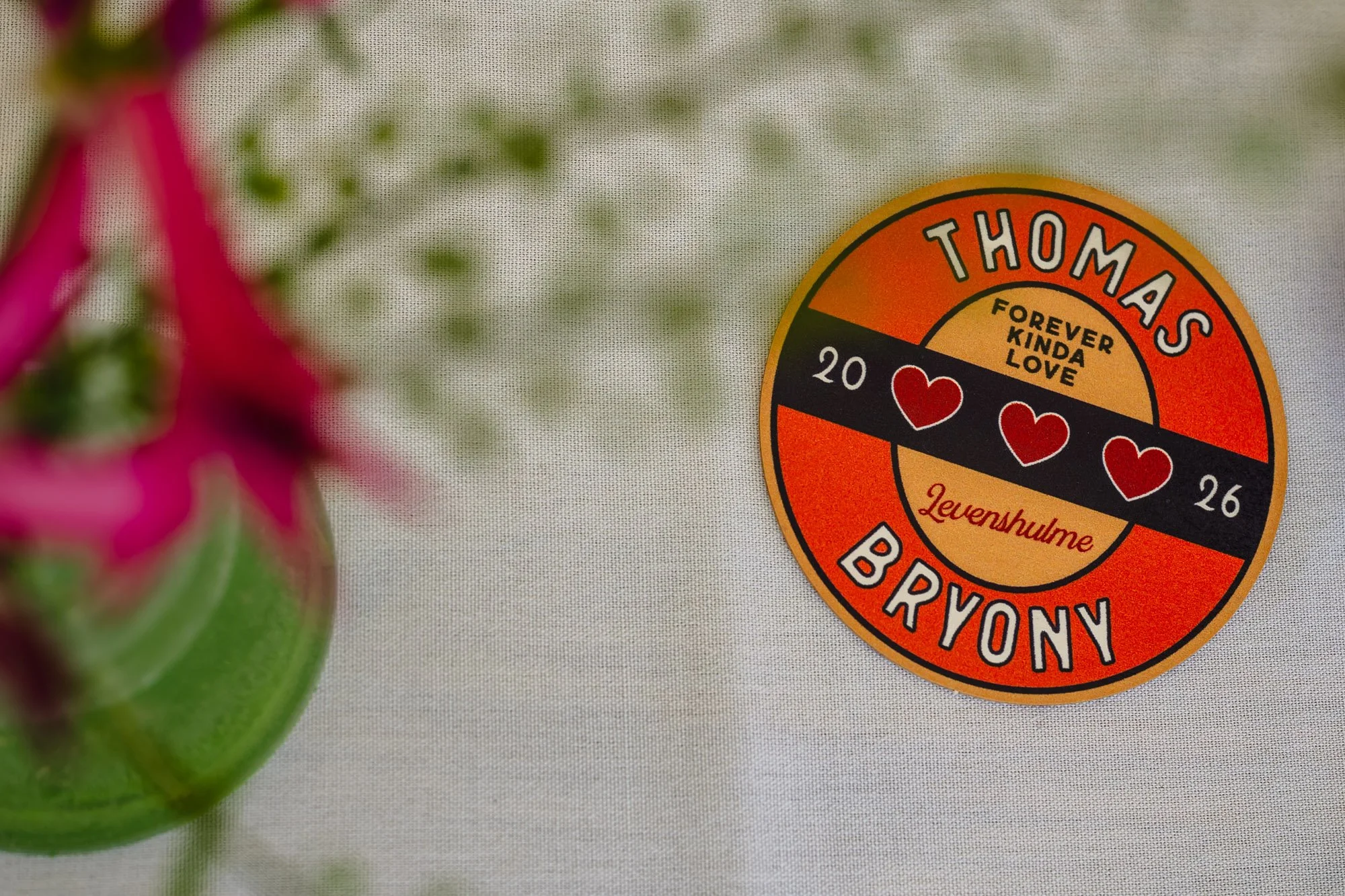  Photograph of a custom beermat. It says Thomas and Bryony, and has the date of their wedding at the Klondyke in Manchester 