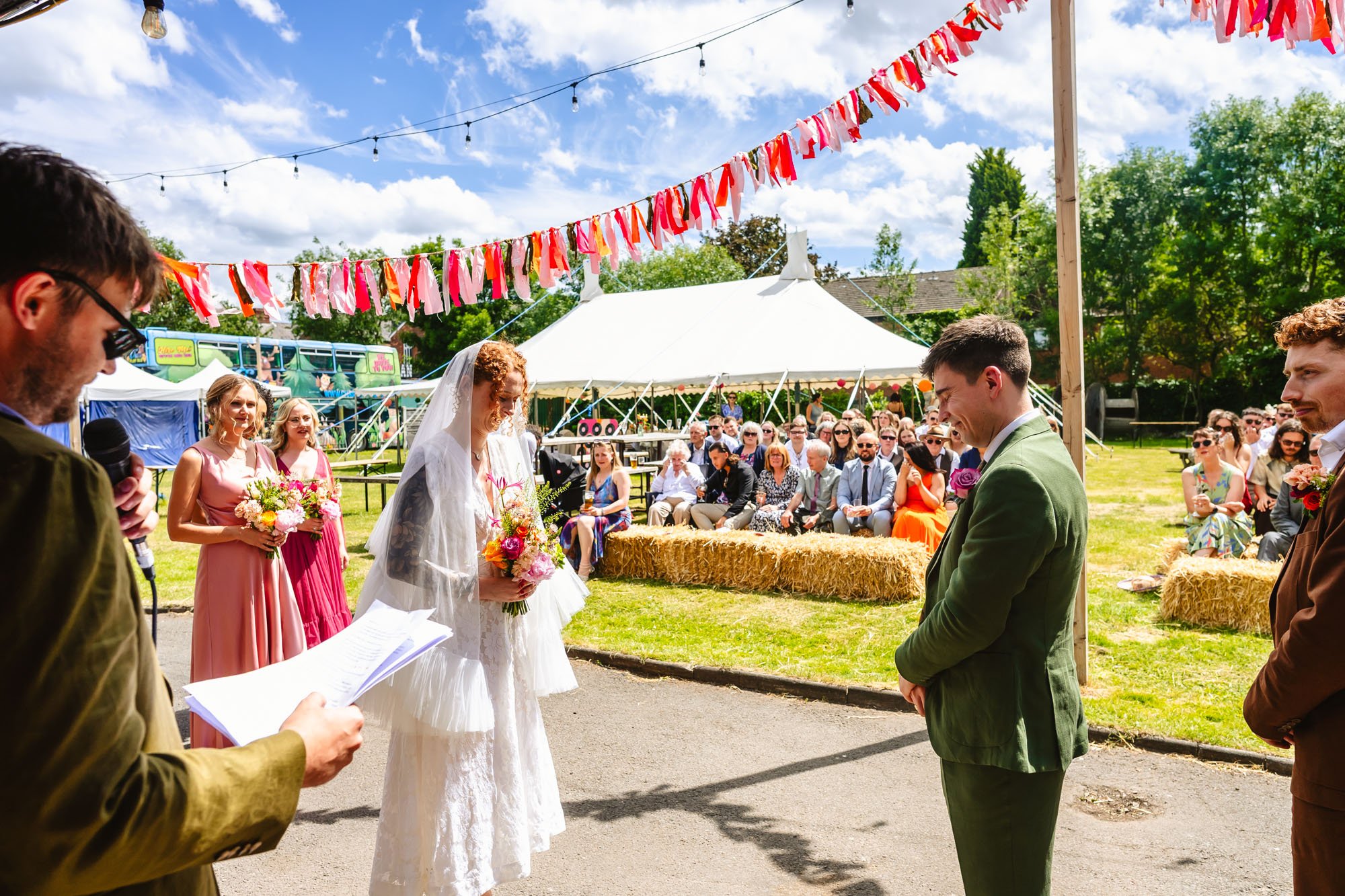  A man and a woman stand facing each other during their outdoor wedding ceremony in Manchester. 