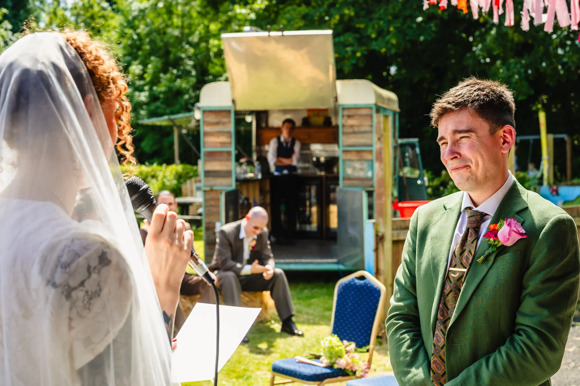  Photograph of a woman reading her vows to her husband during their wedding ceremony 