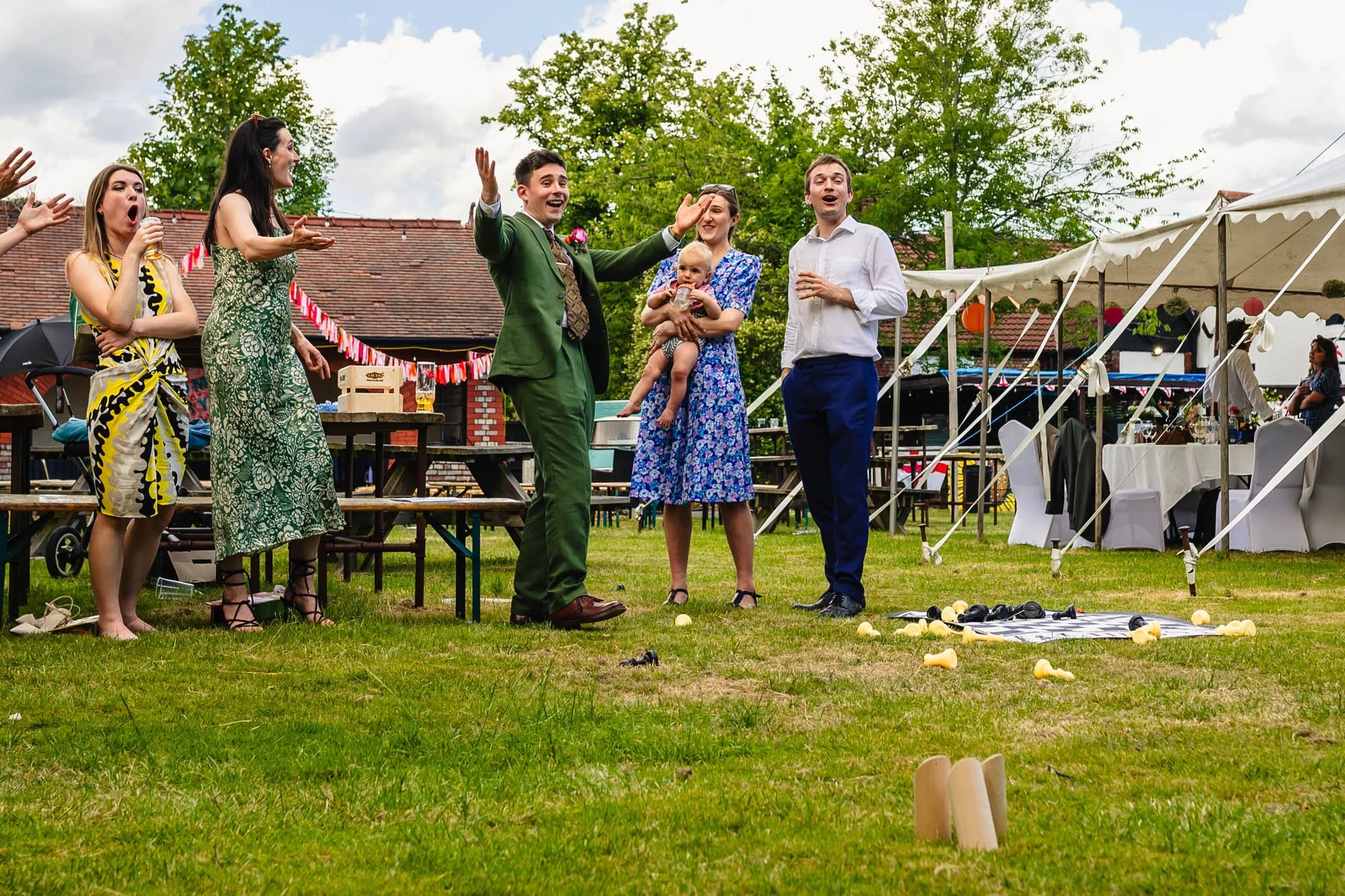  photo of a few guests playing Kubb at a wedding 
