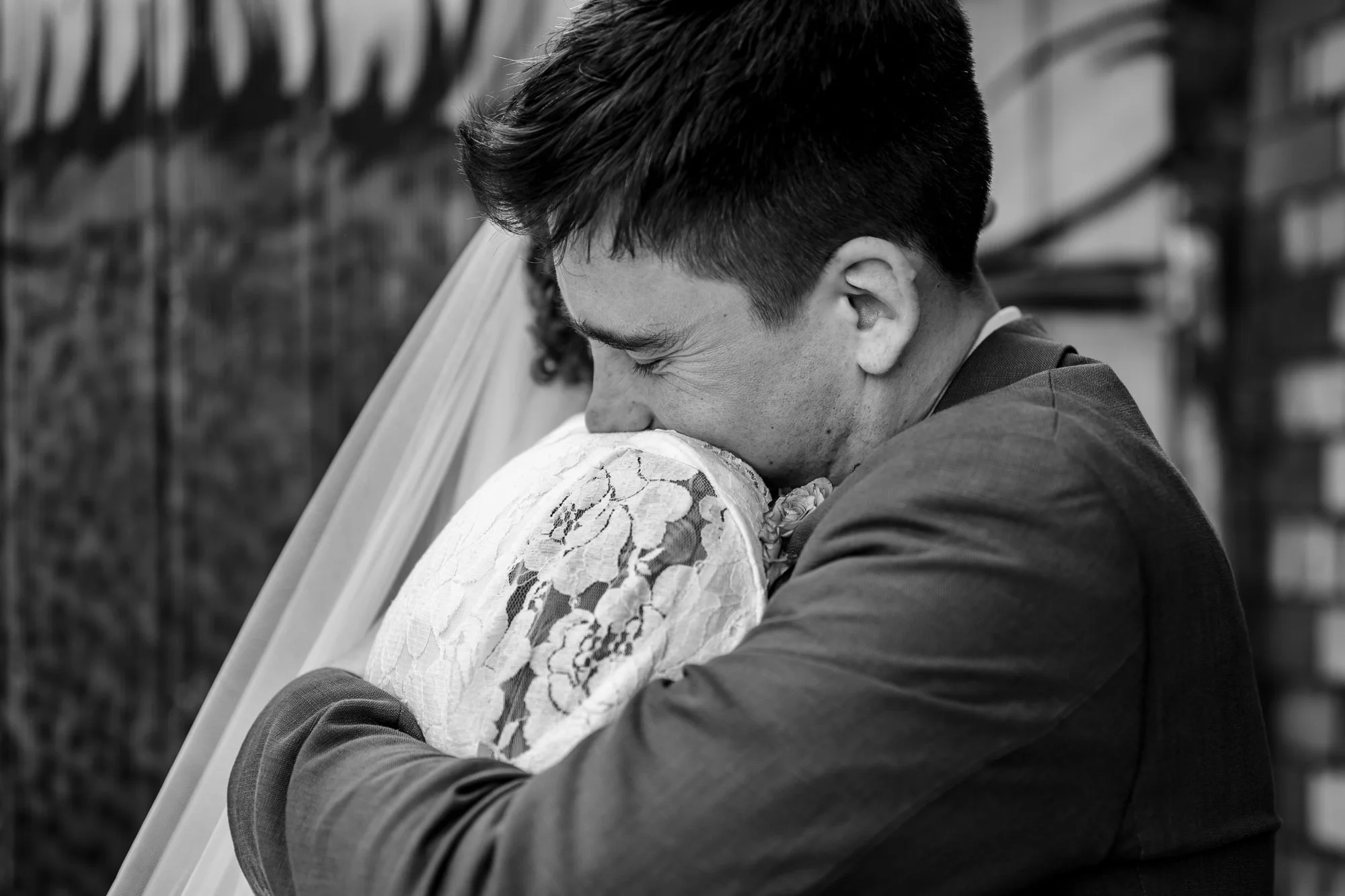  black and white image of a couple hugging 