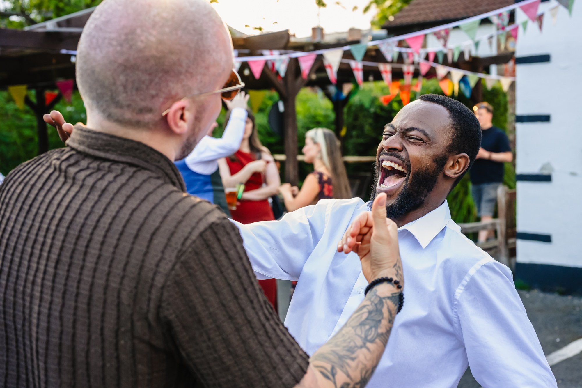  Photograph of two wedding guests laughing 