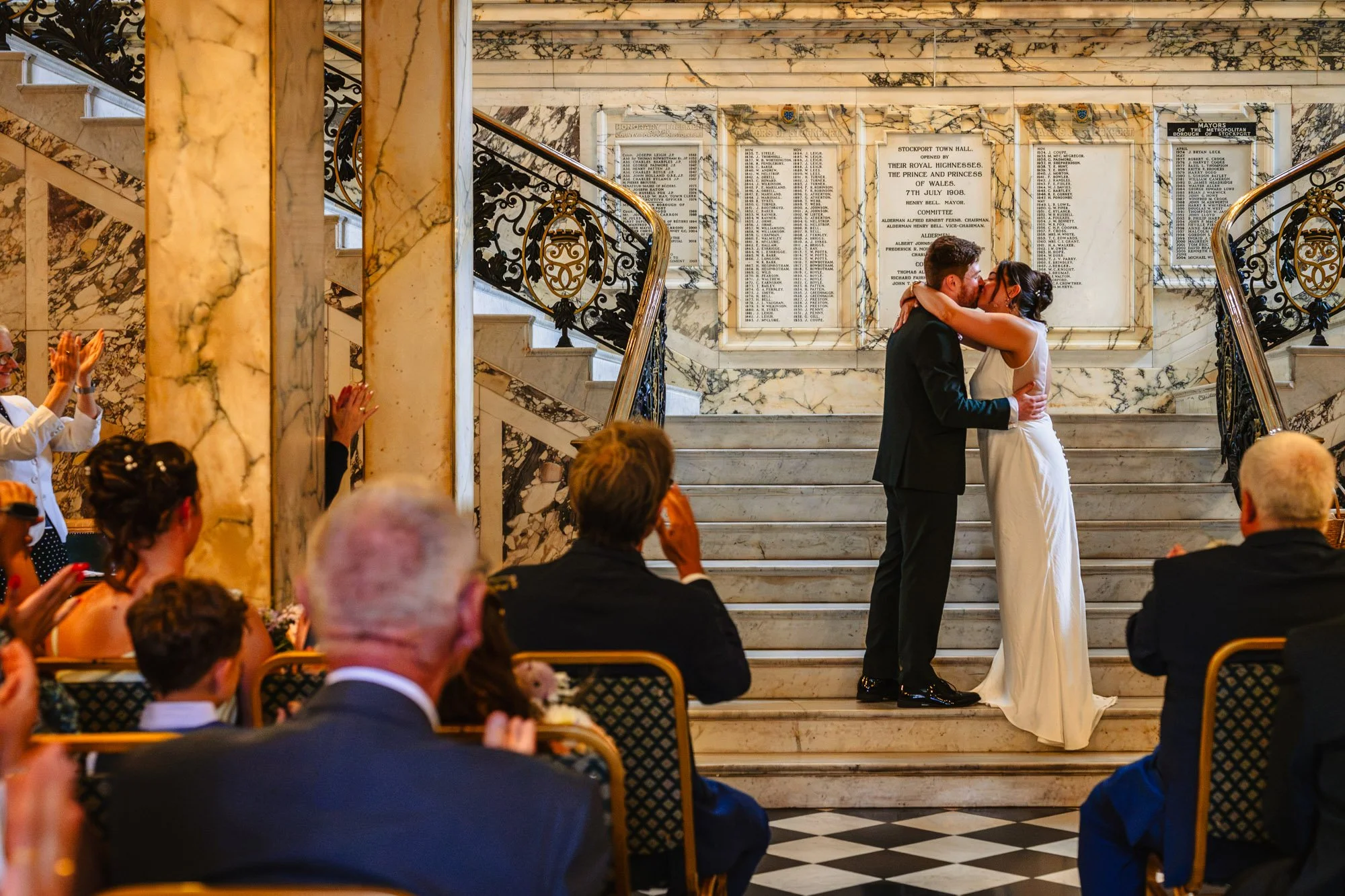 A bride and groom kiss at the end of their wedding ceremony at Stockport Town Hall