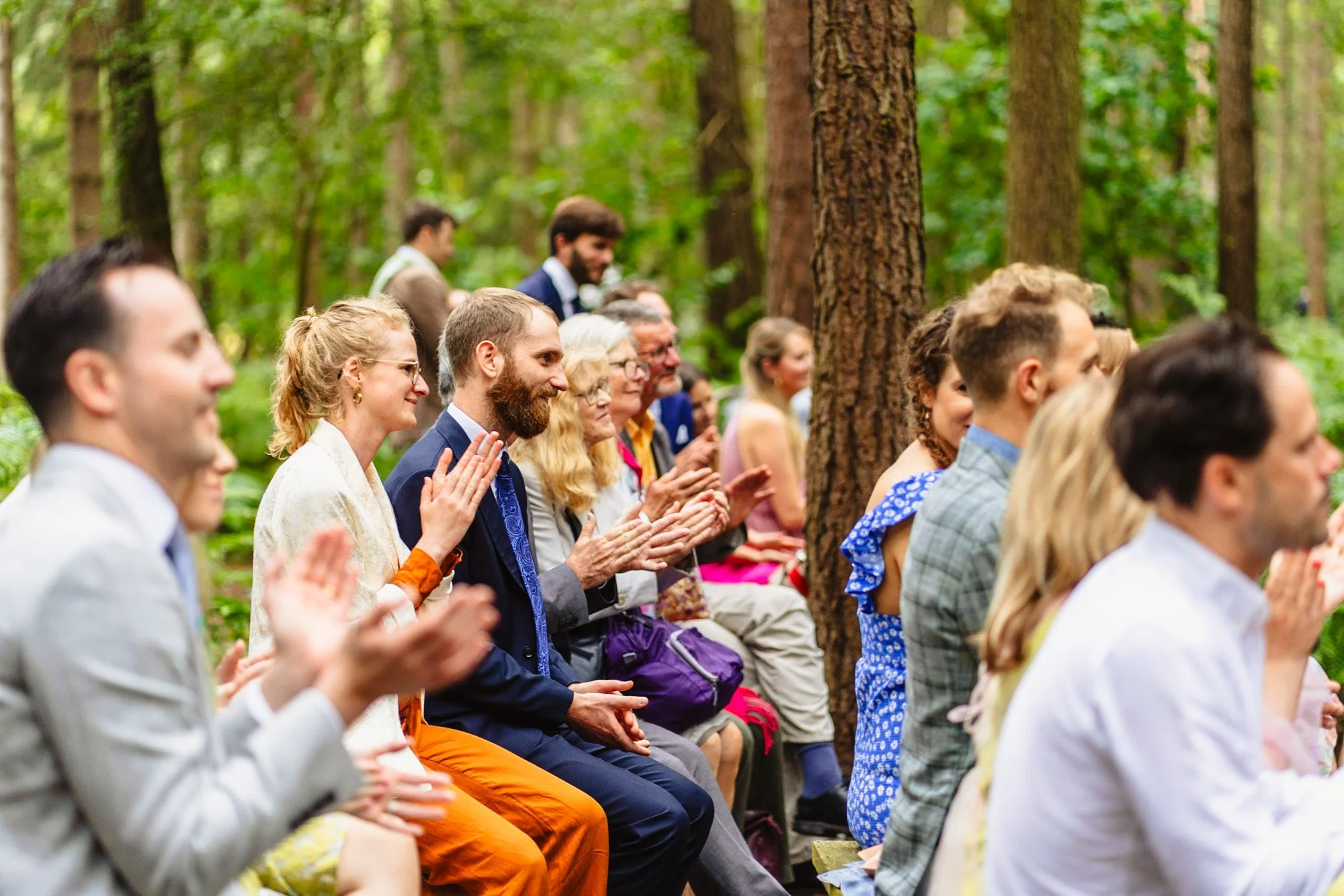 photograph of guests applauding a wedding ceremony at camp Katur in a blog post about sustainable wedding choices