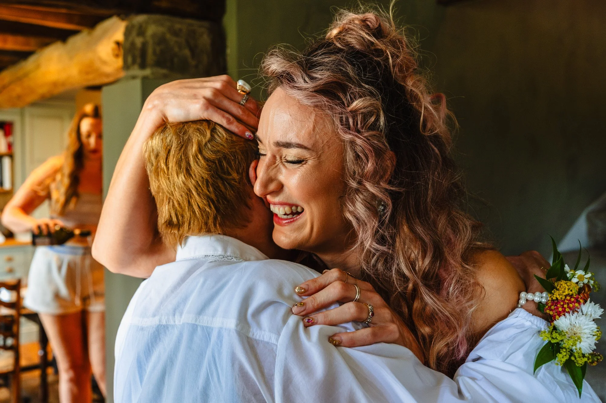 An emotional bride is giving her mum a hug in the onsite accommodation at Duddon Mill Farm just minutes before her wedding ceremony