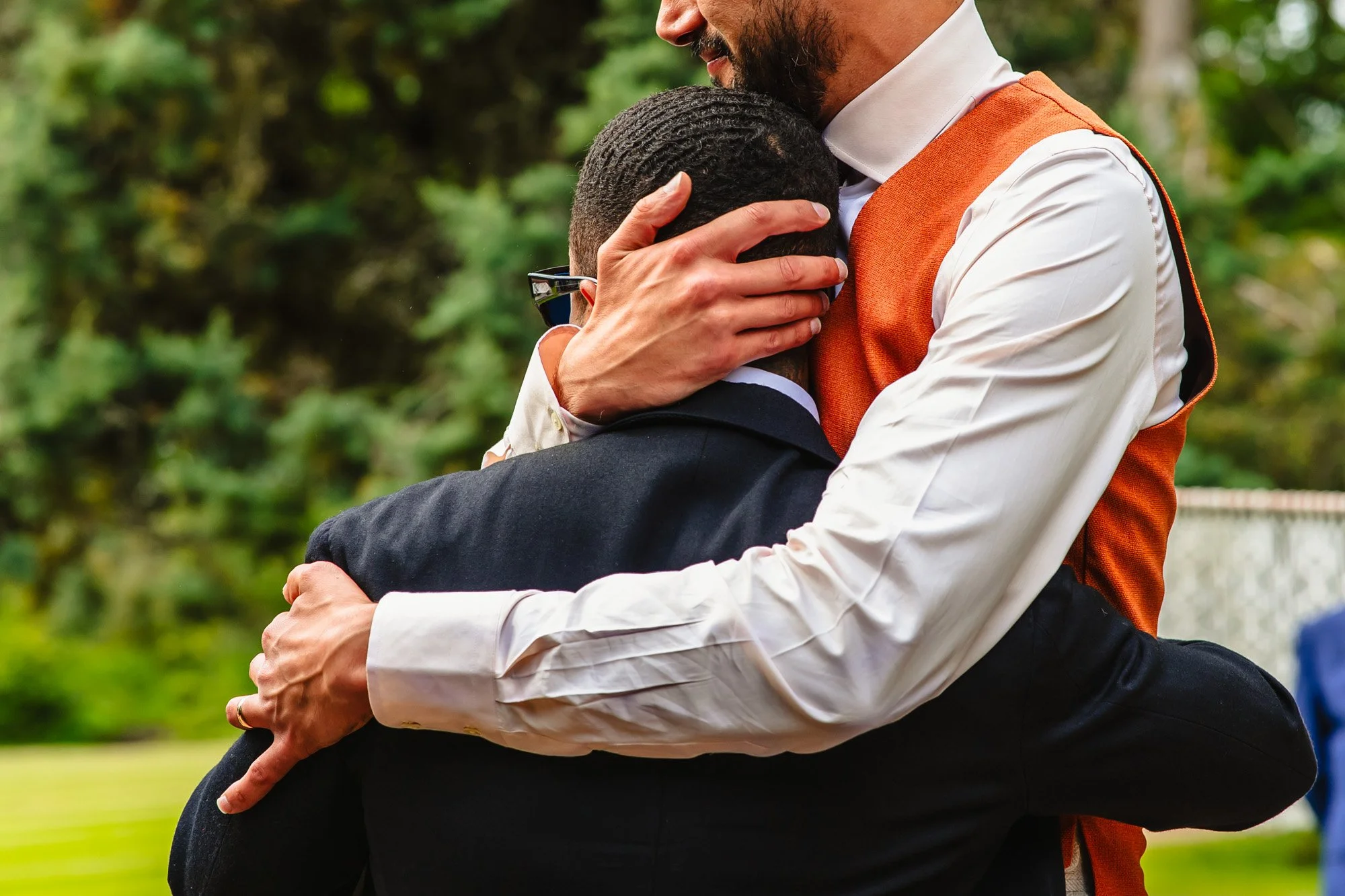 Two men hug during speeches at whatton house tipis