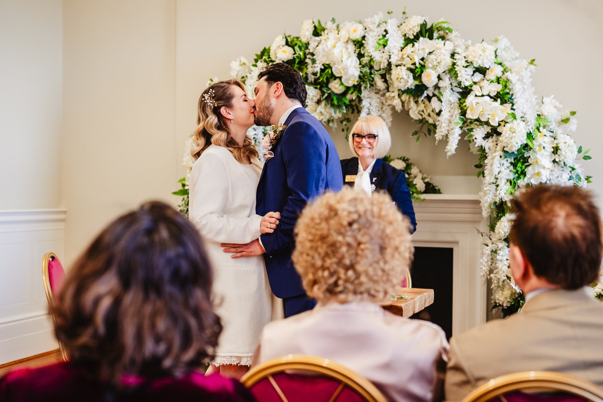Photograph of a couple's first kiss as a married couple during their wedding ceremony at St George's Hall in Liverpool
