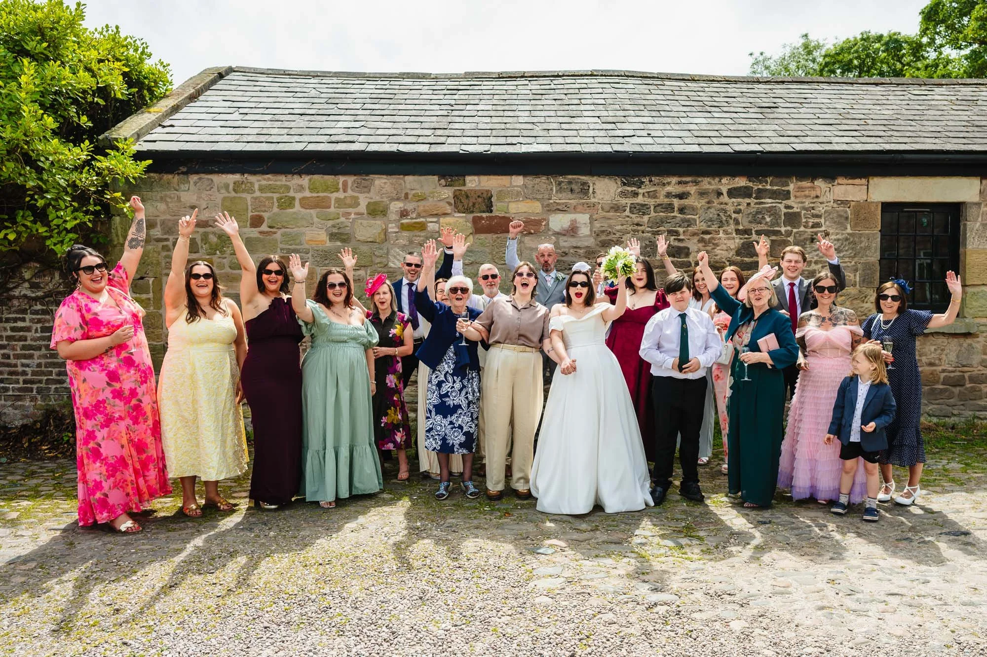 Group photograph of a wedding party at Lost Wirral wedding venue