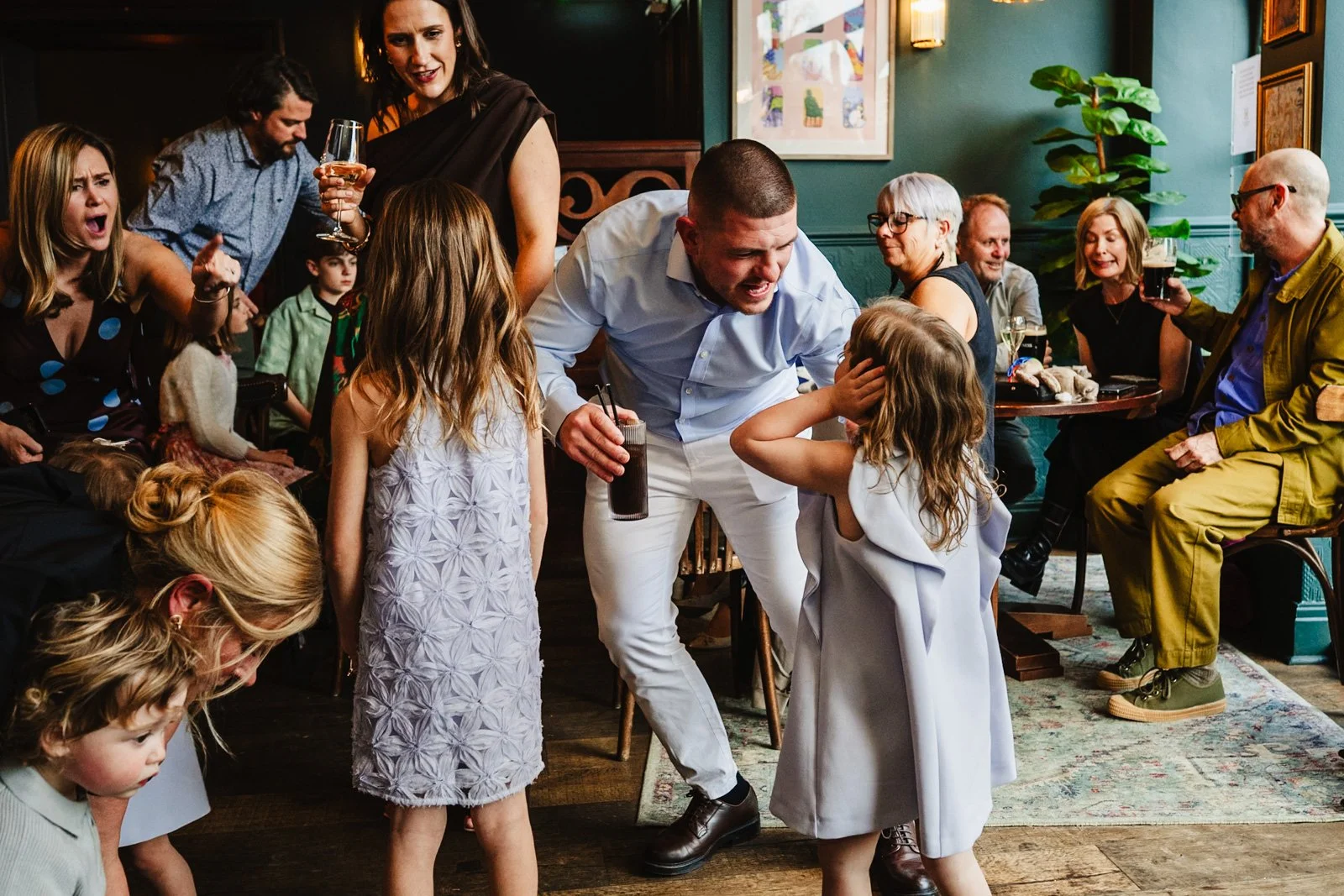 photograph of various groups of people at a wedding reception in a pub by documentary wedding photographer Caroline Goosey