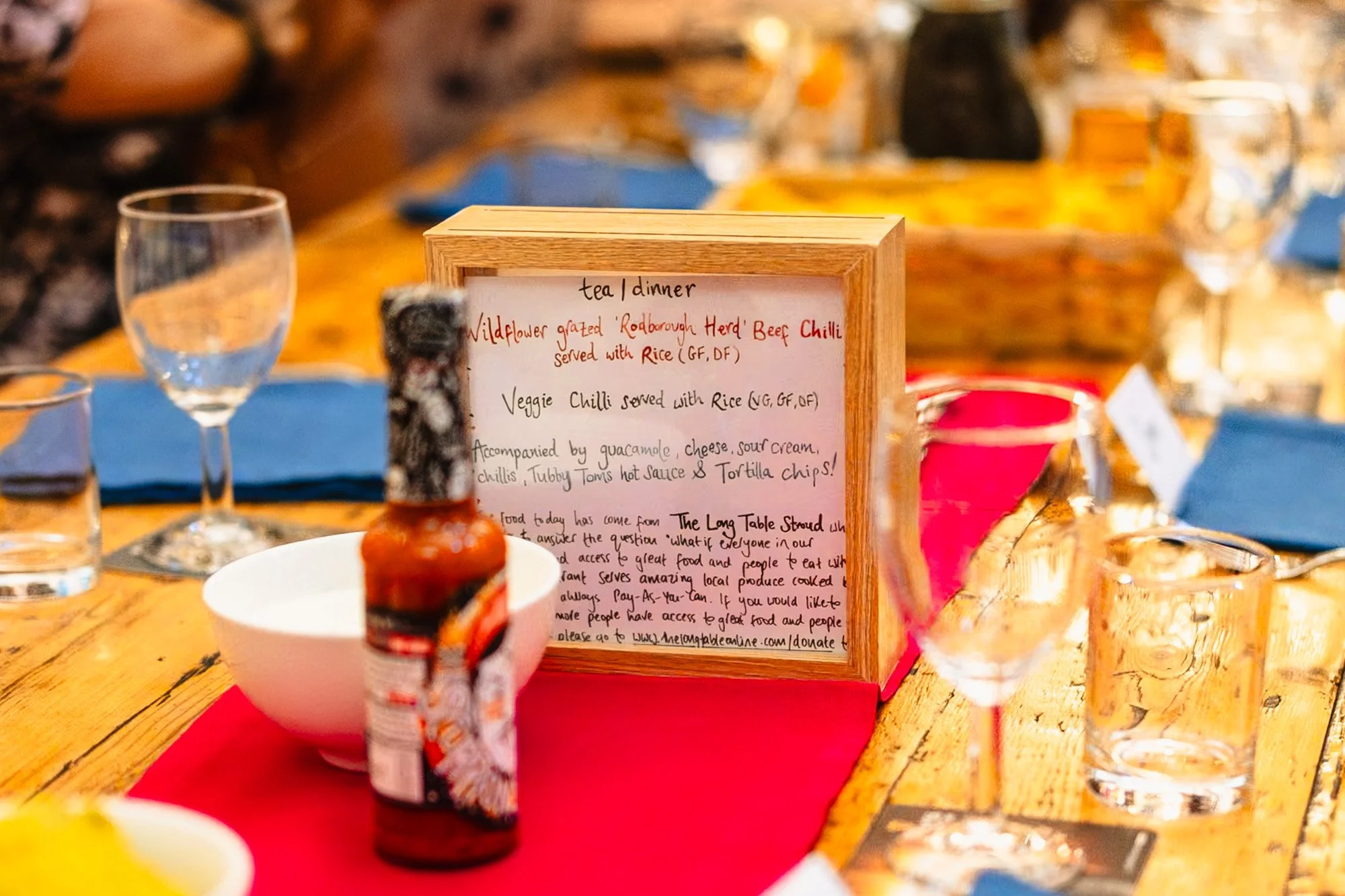 photograph of a table at a wedding meal, with the meal option explained. It's in a blog post about sustainable wedding choices.