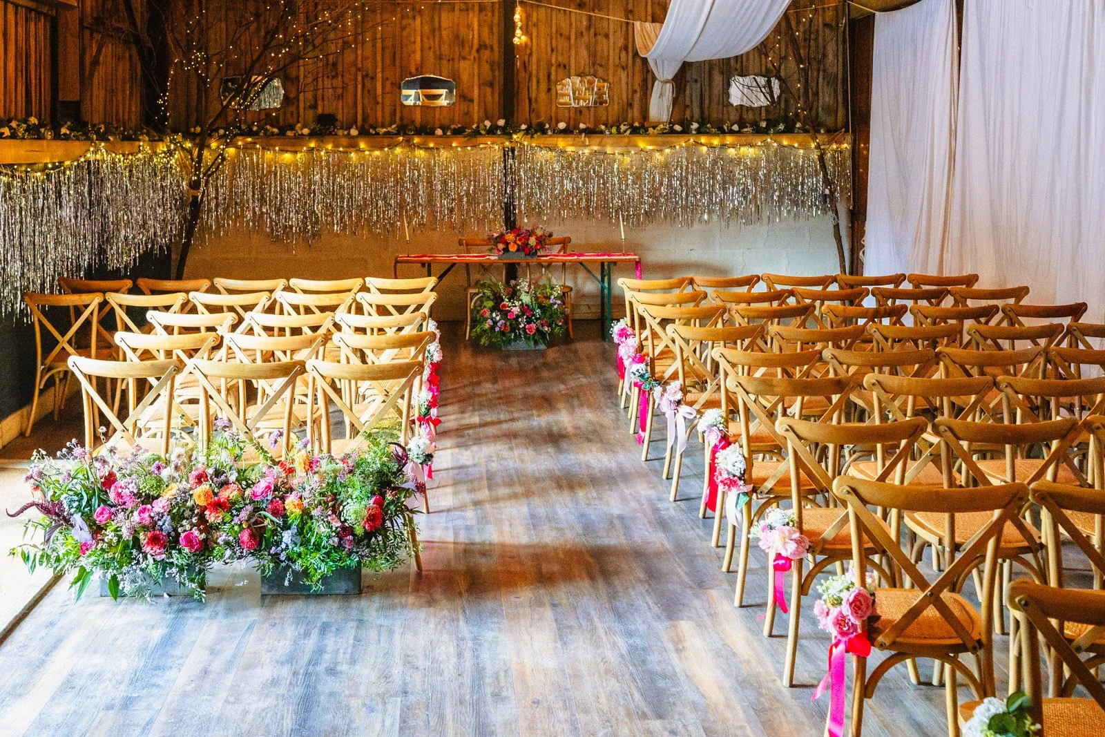 The internal barn space at Peak District Holiday Barn, decorated ready for a wedding ceremony