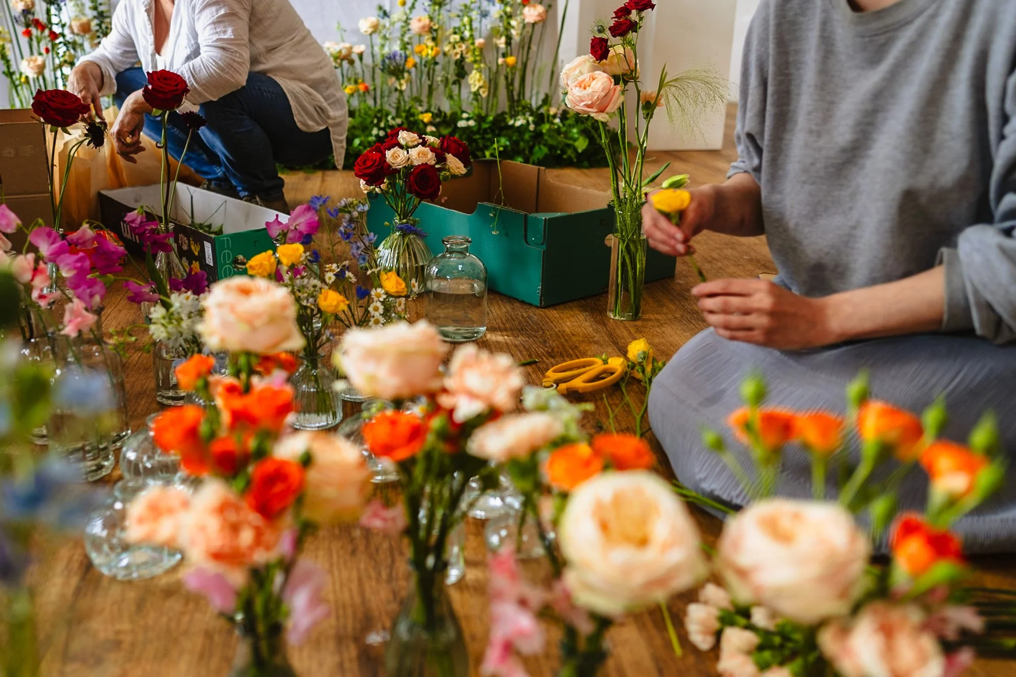 documentary photograph of two florists preparing flowers at a wedding in North Wales