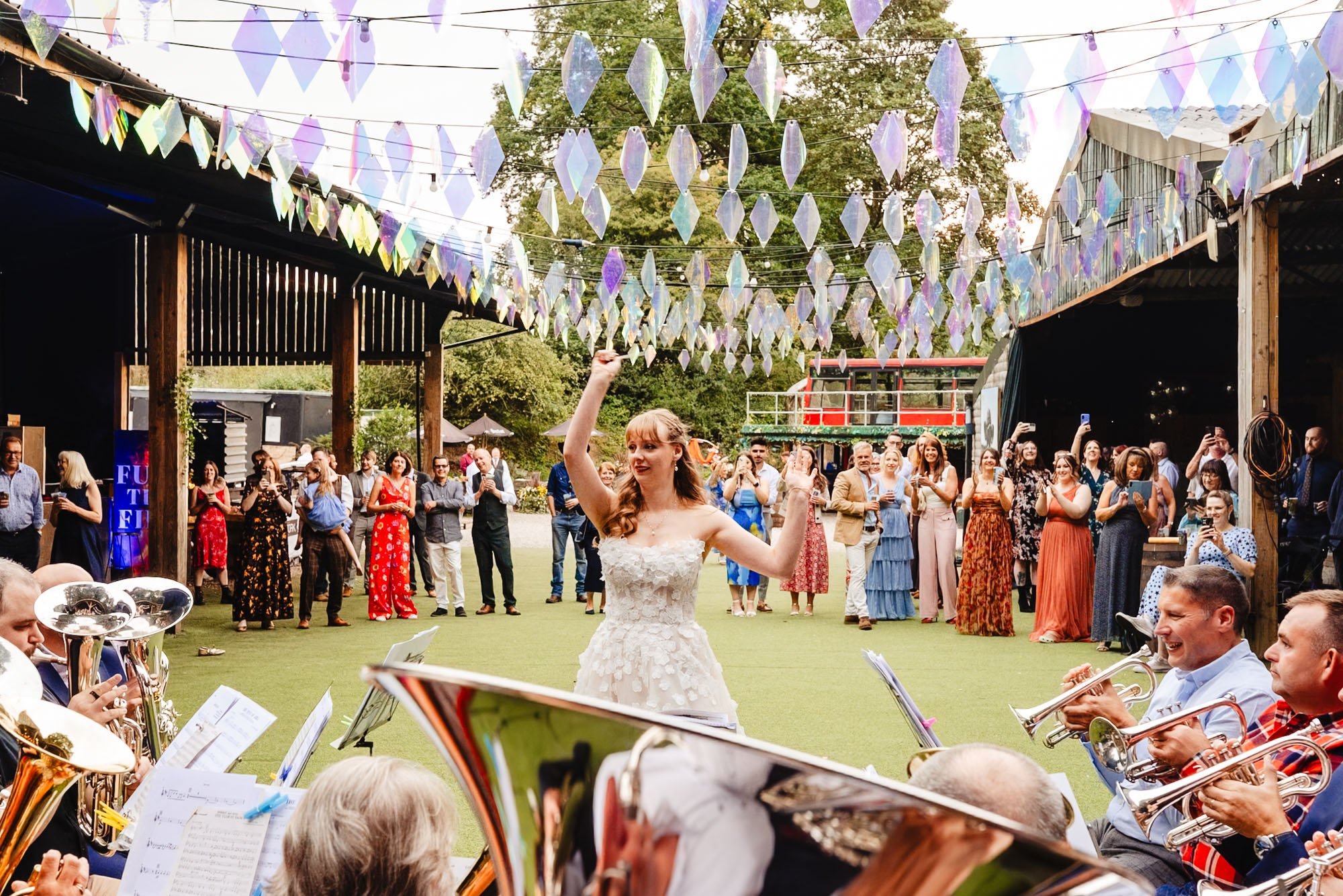 photograph of a bride conducting an orchestra at her wedding at Whitebottom farm as part of a blog post about sustainability at weddings