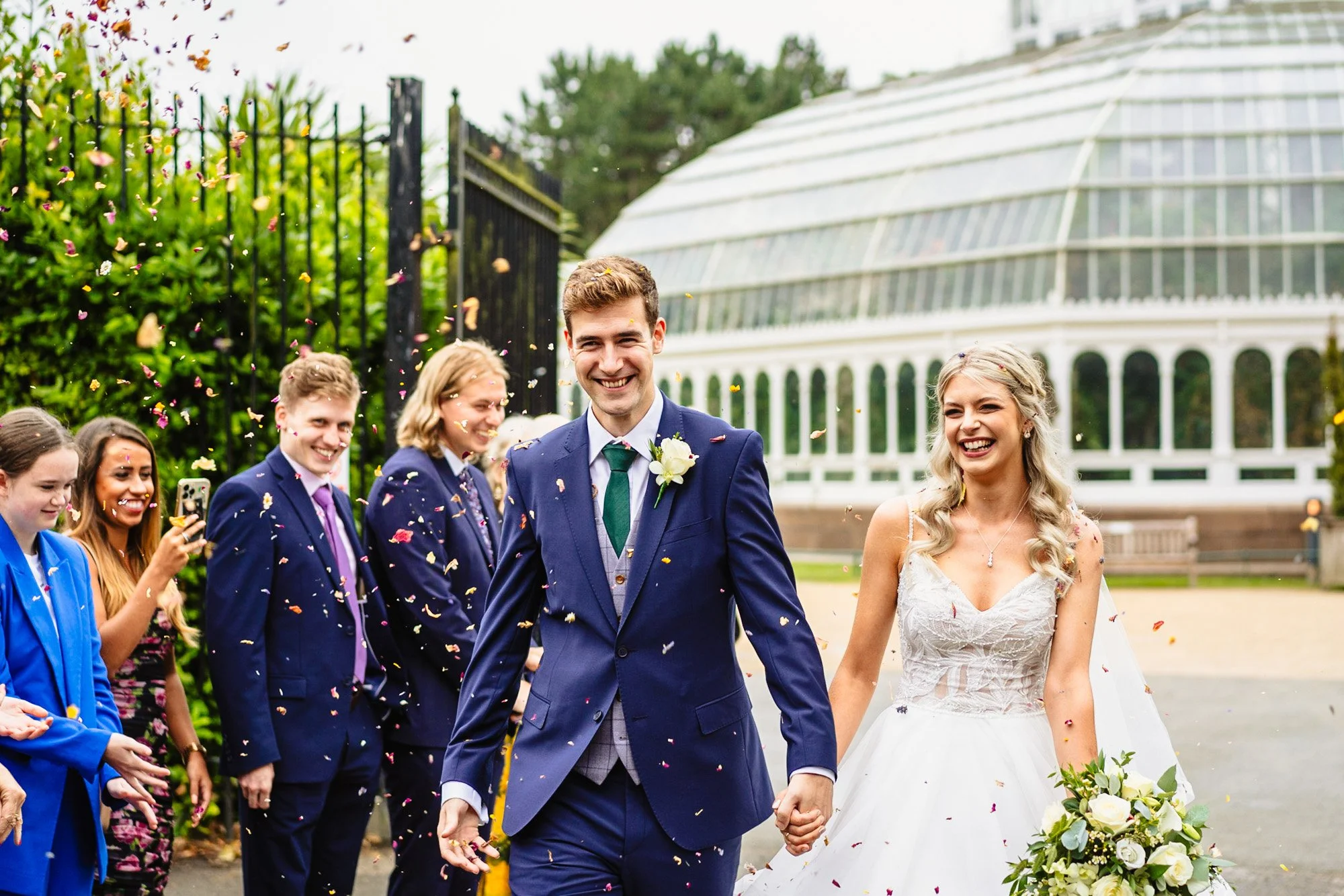 In a post about sustainable wedding choices, an image of a bride and groom walking through confetti outside the Palmhouse in Liverpool