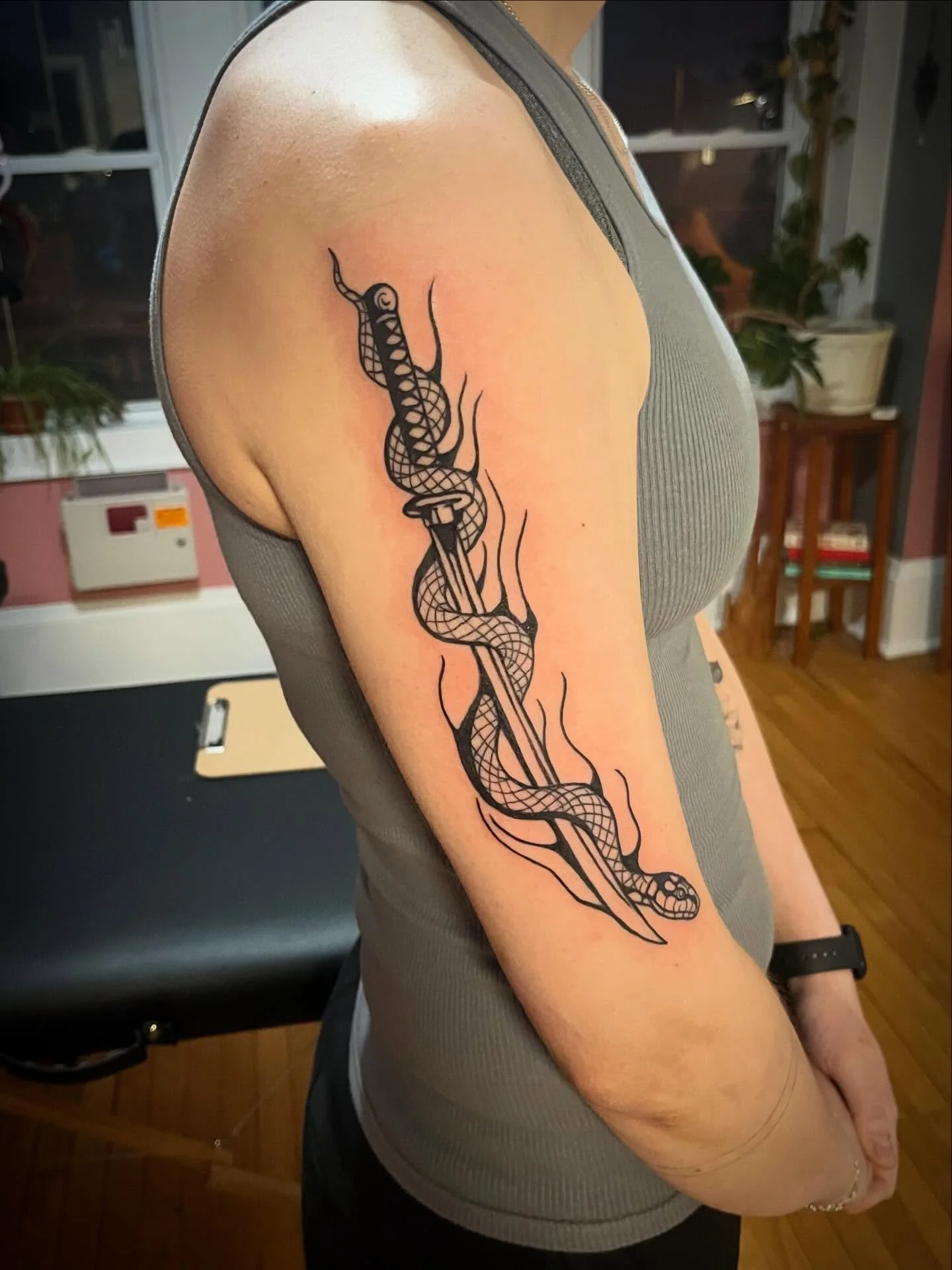 A slithering friend #tattoo #milwaukeetattoos #snaketattoo #snakesword