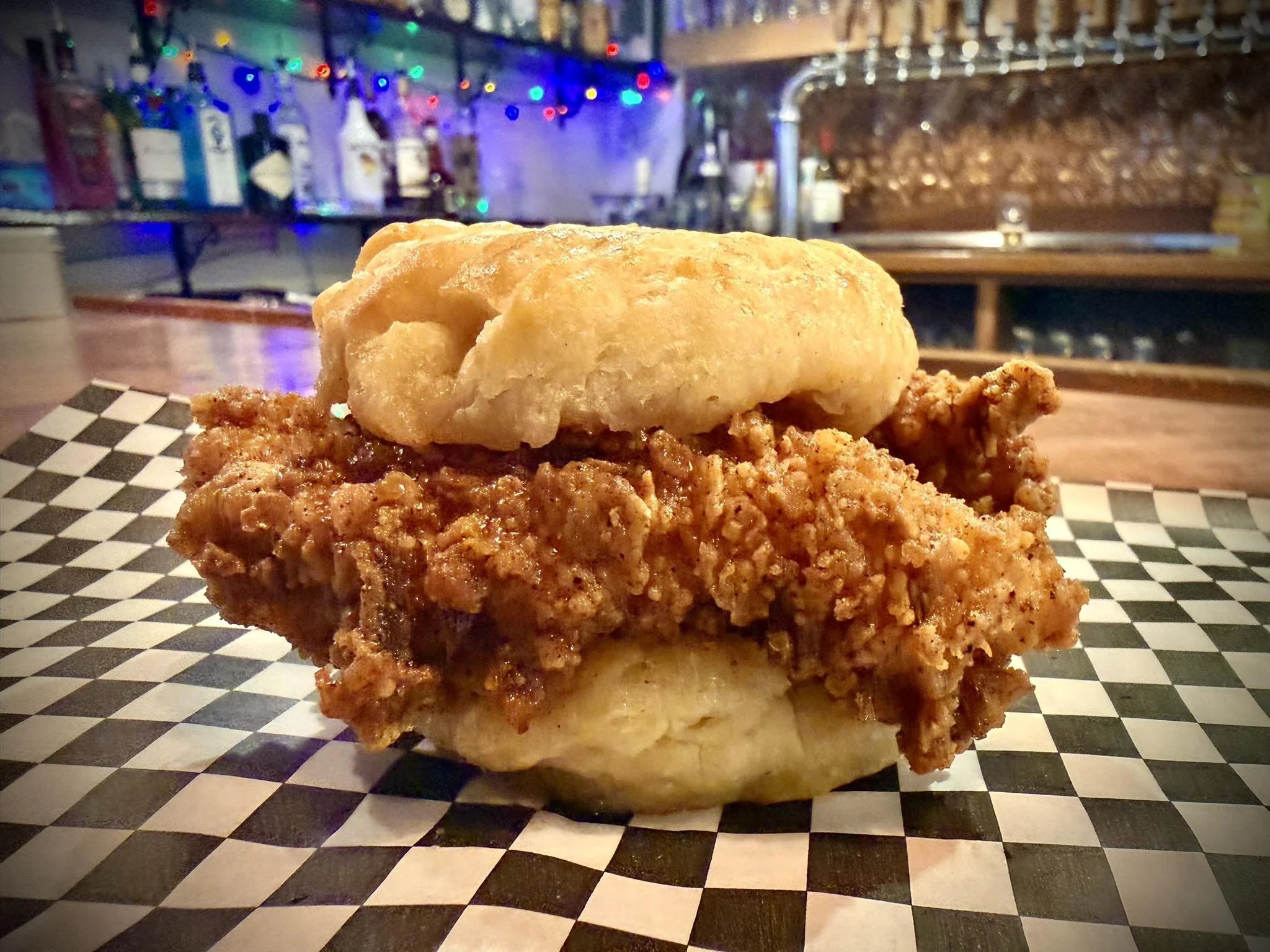 Golden fried chicken served on a flaky homemade biscuit for Sunday brunch.