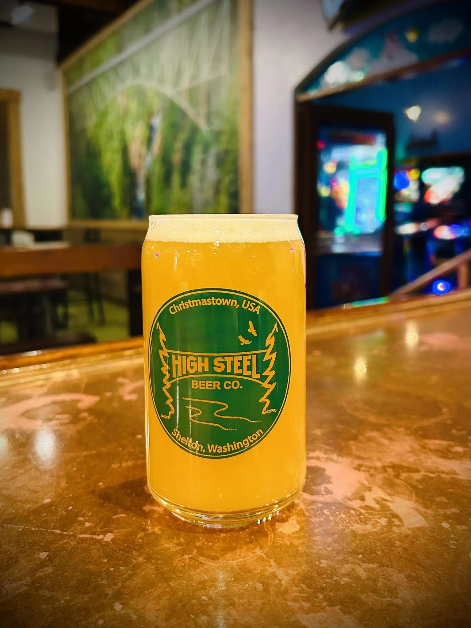 Hazy golden craft beer served in a High Steel Beer Co. pint glass at the taproom.