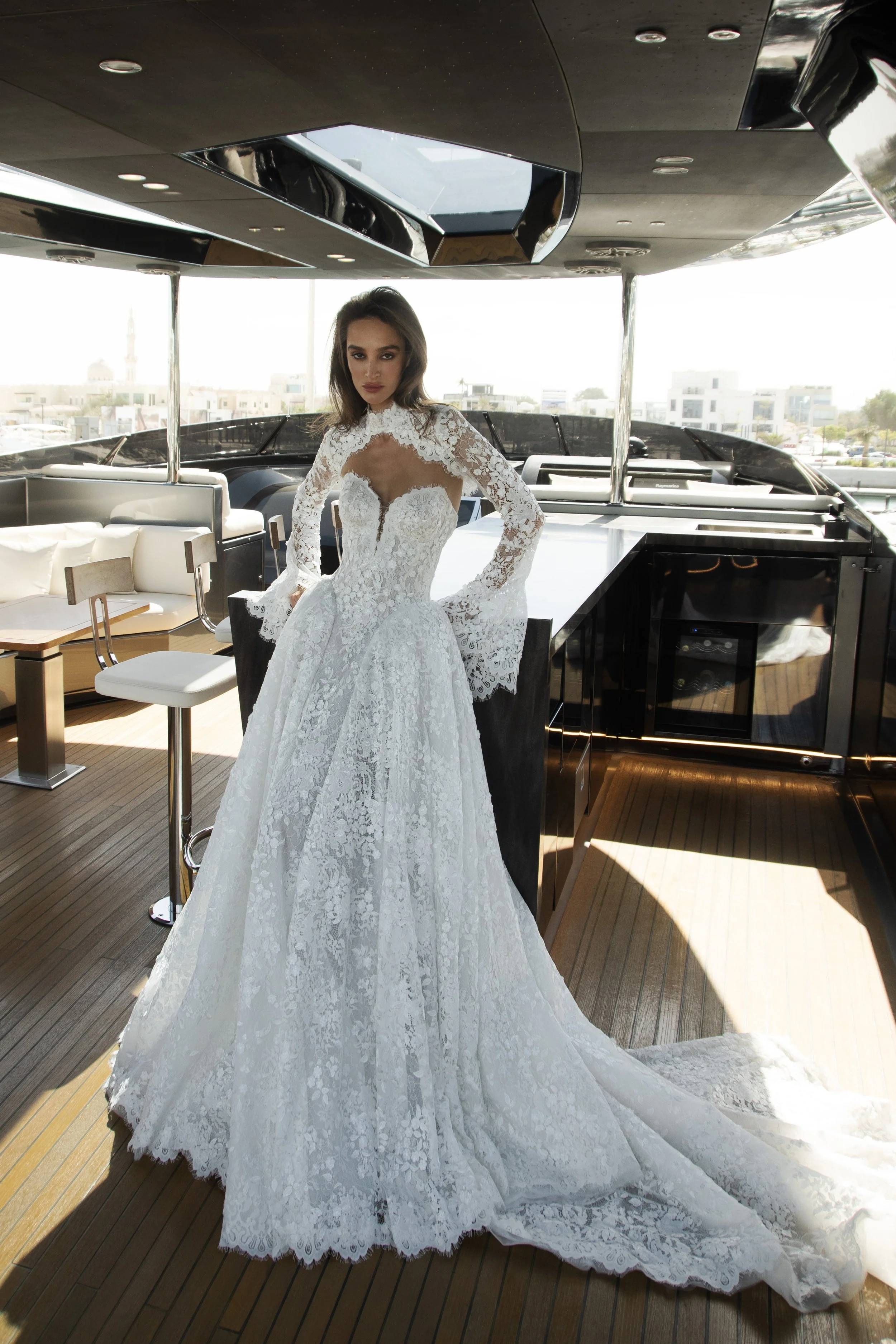 Bride in the Venice gown by Natalia Romanova featuring intricate lace, sheer detailing, and a romantic ball gown silhouette