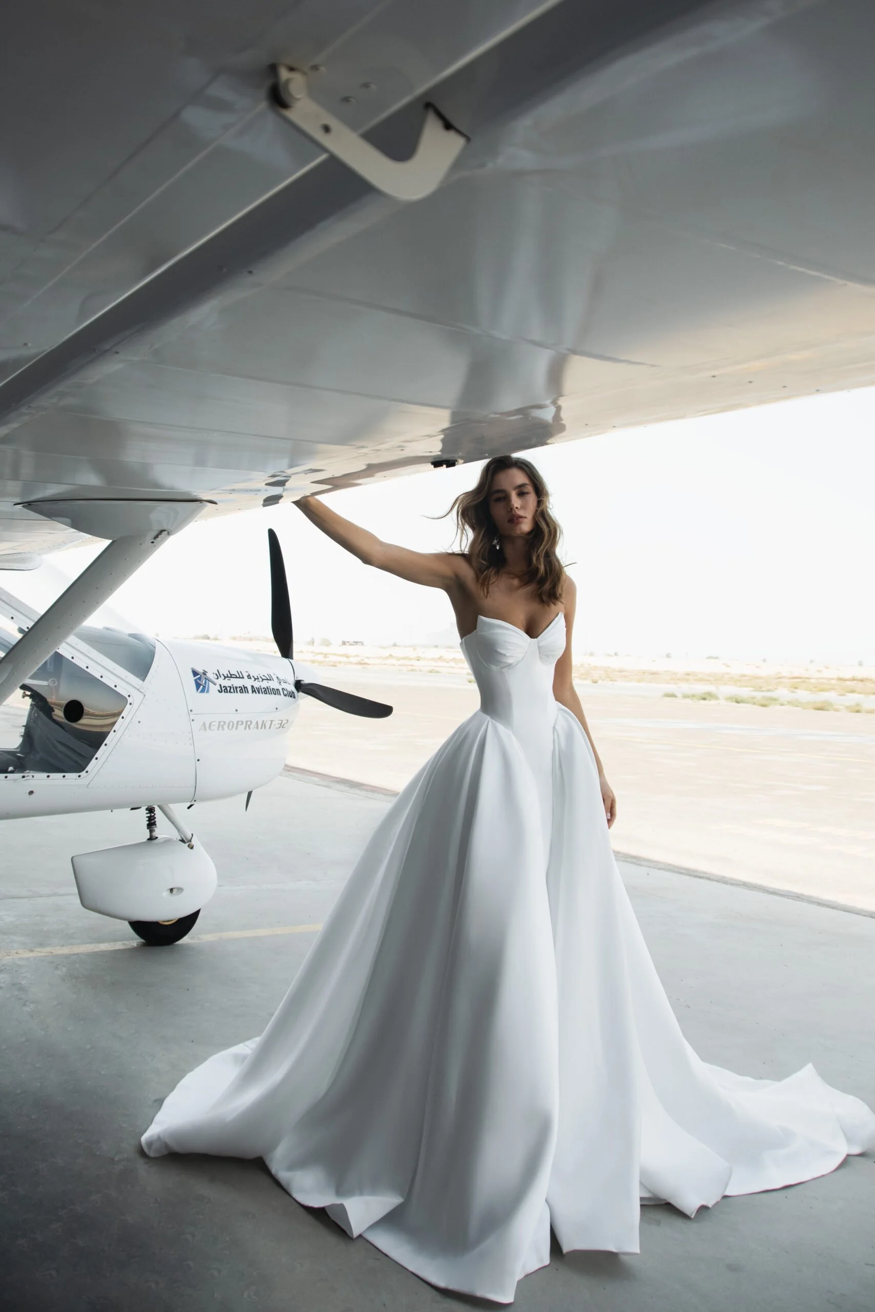 Bride wearing the Vivian wedding dress by Romanova, a satin ball gown with a full skirt and timeless silhouette