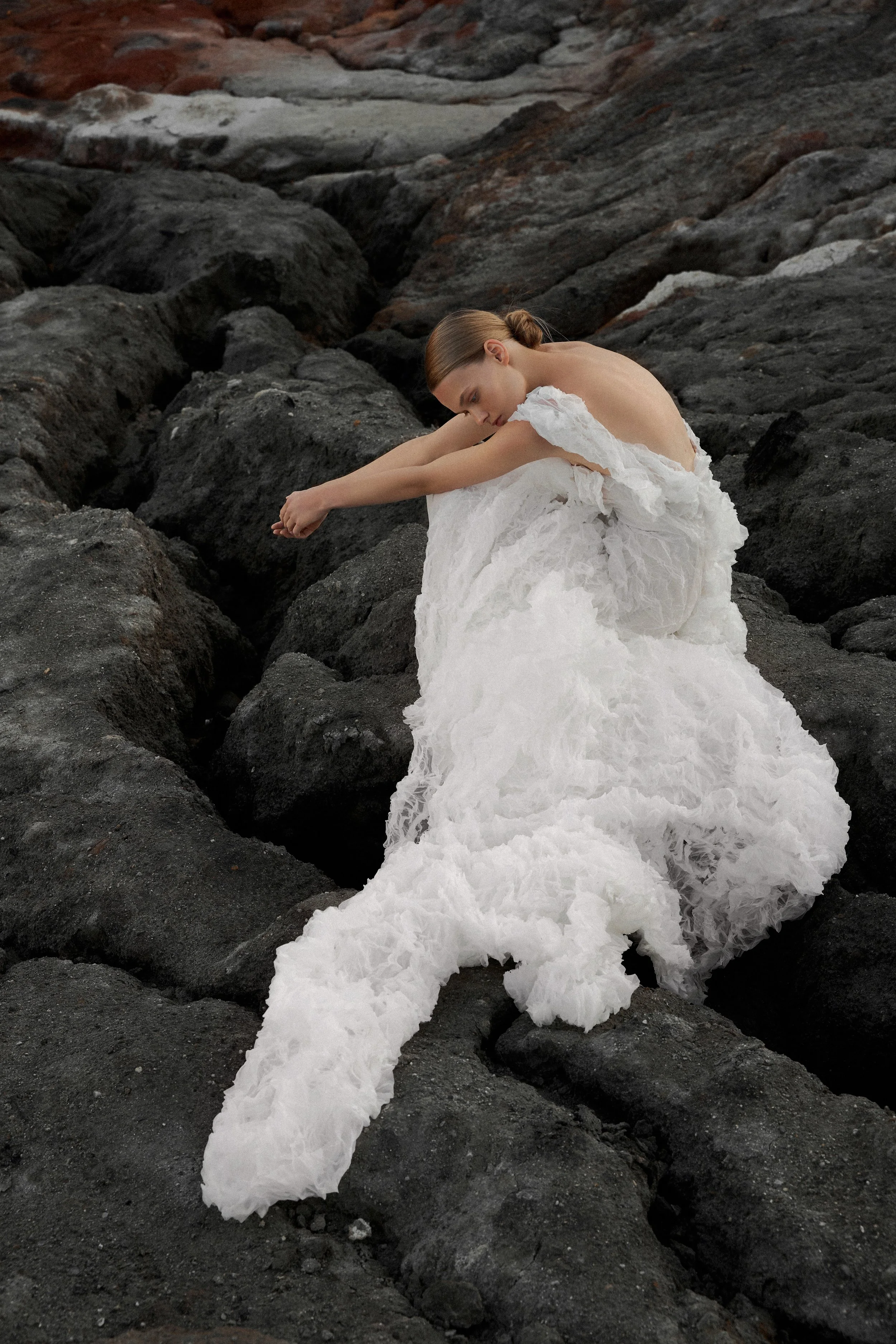 Lana Marinenko sculptural one-shoulder wedding dress with cascading ruffles, fitted silhouette, and sweeping train — a couture bridal gown for modern, fashion-forward brides