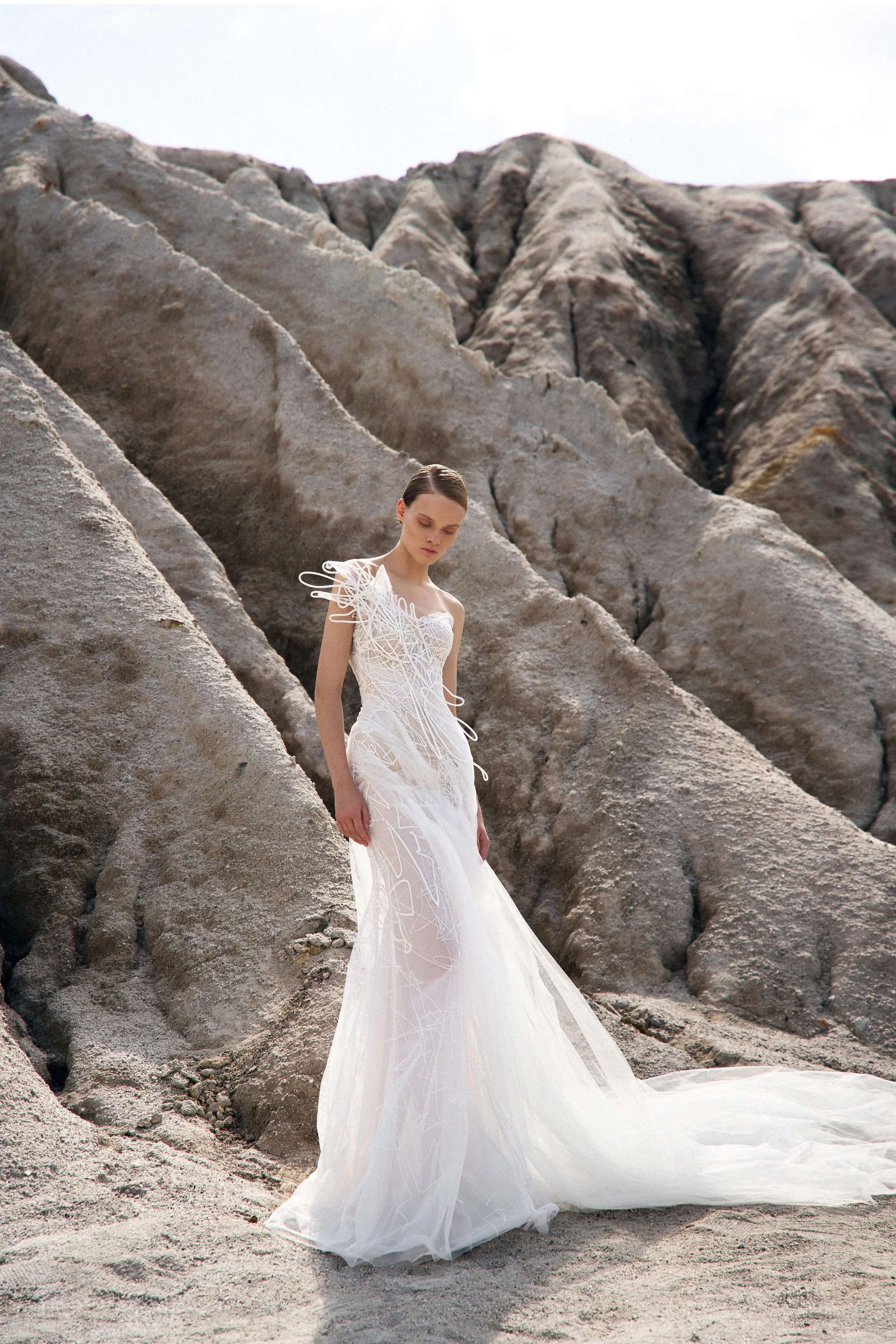 Heather by Lana Marinenko: a lace and tulle mermaid wedding dress with structured details. Effortless and elegant. Book your NYC appointment.
