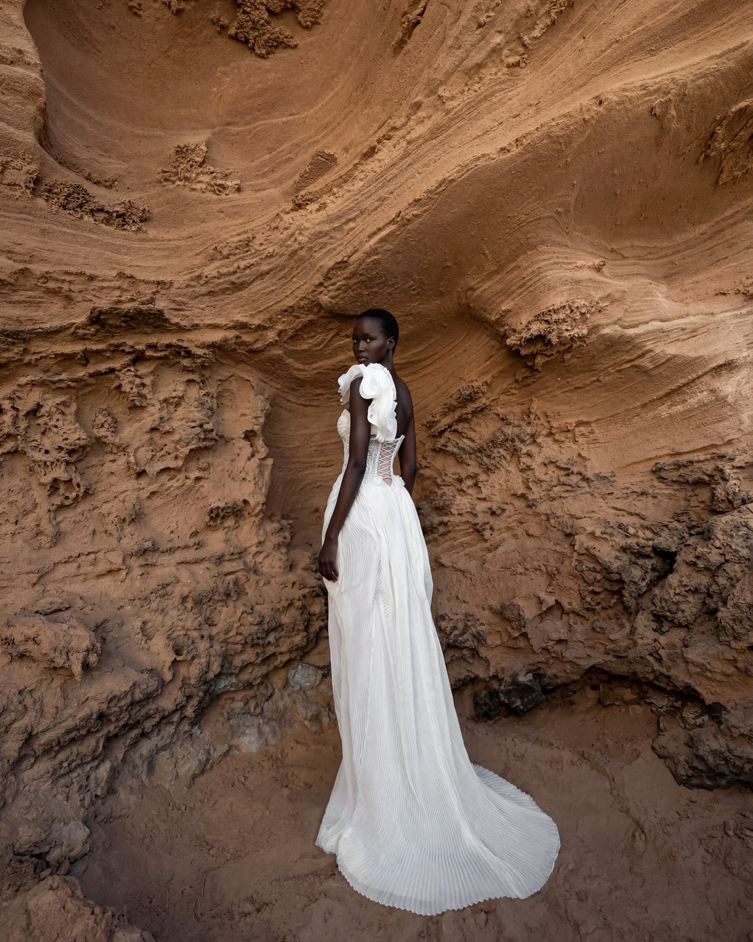 Asymmetrical wedding dress by Lana Marinenko made from pleated organza with a modern sculptural silhouette