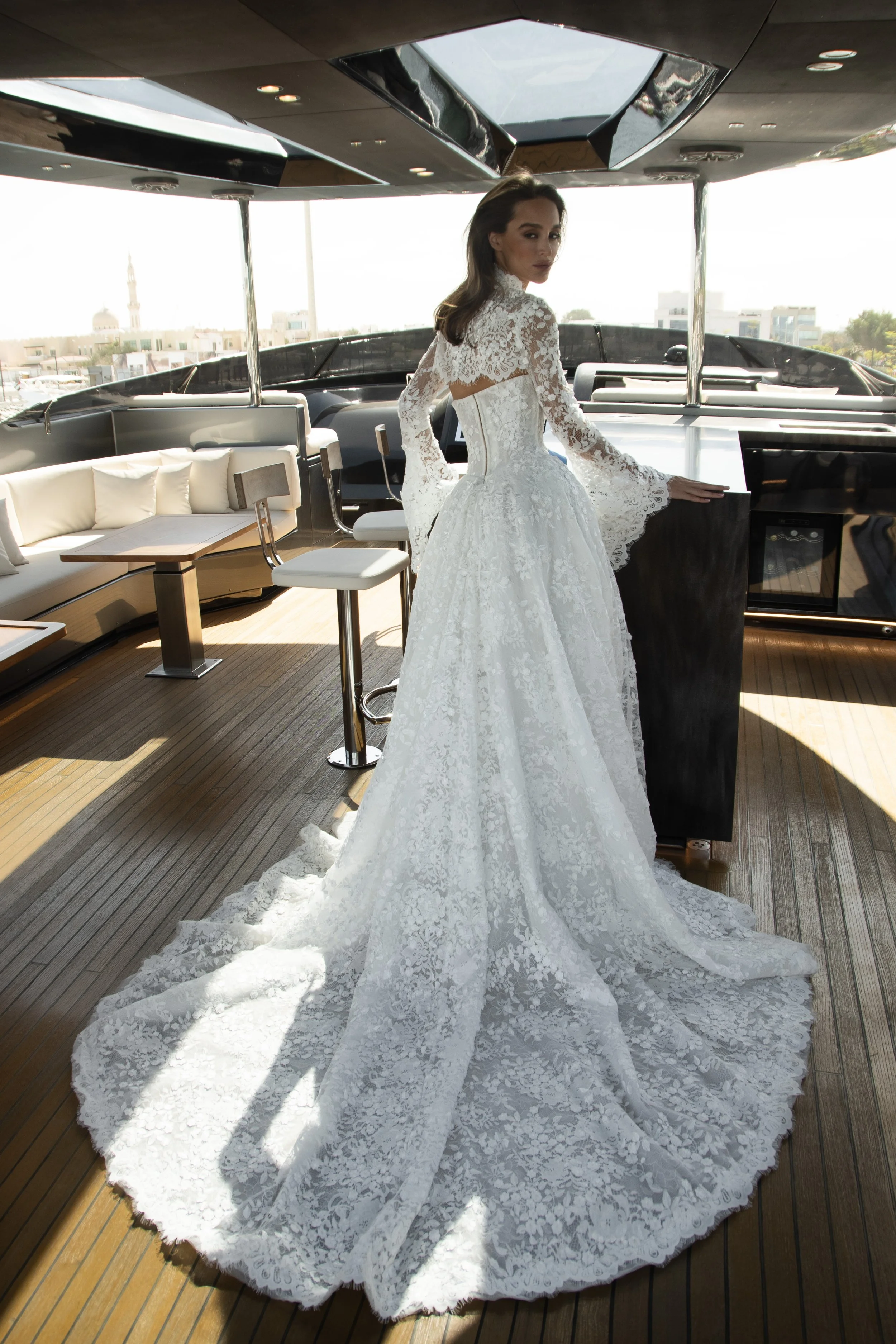 Bride in the Venice gown by Natalia Romanova featuring intricate lace, sheer detailing, and a romantic ball gown silhouette